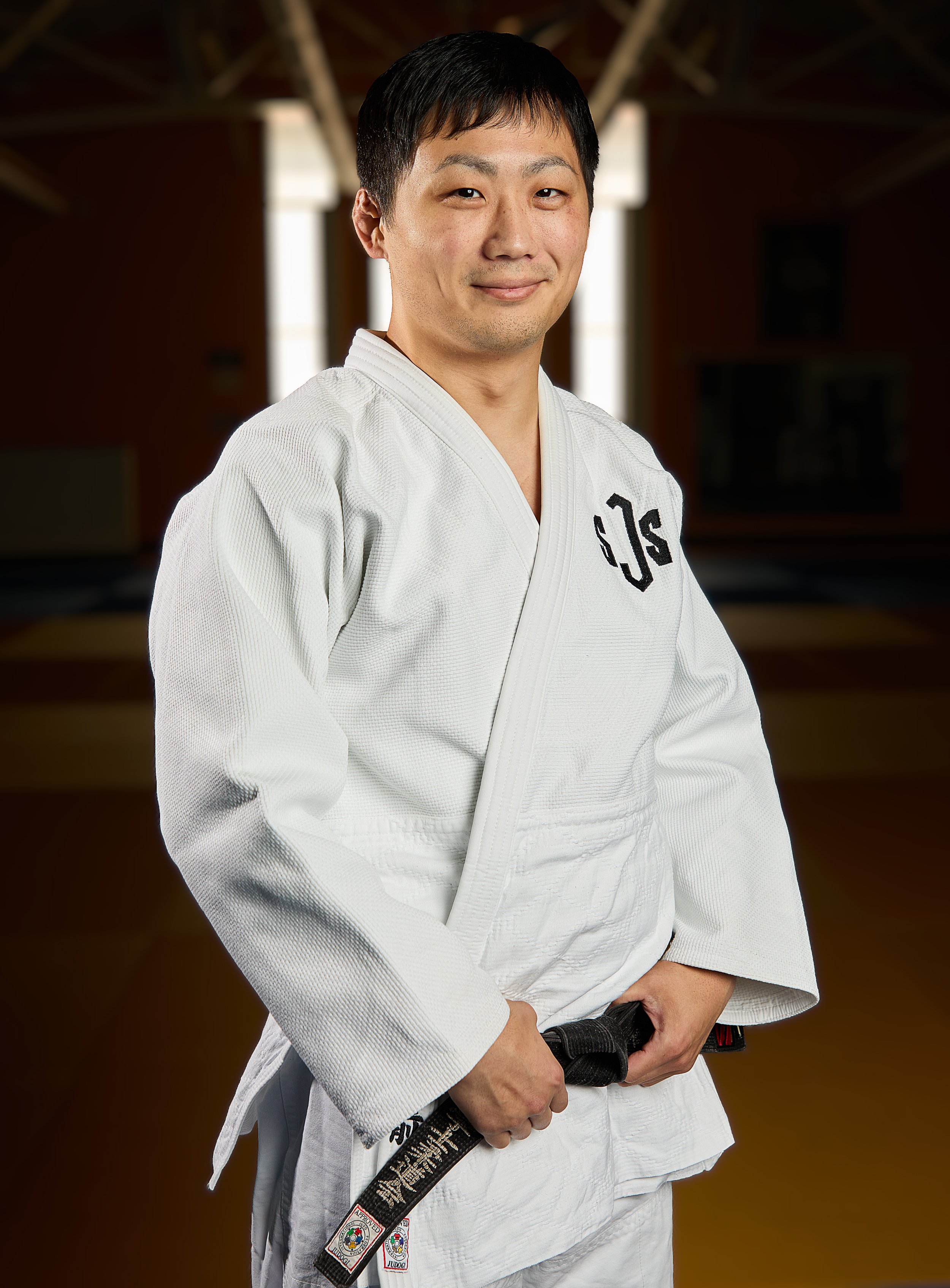 Logo of a sports team featuring a stylized yellow and blue helmet with a crest, and the word "JUDO" written below.