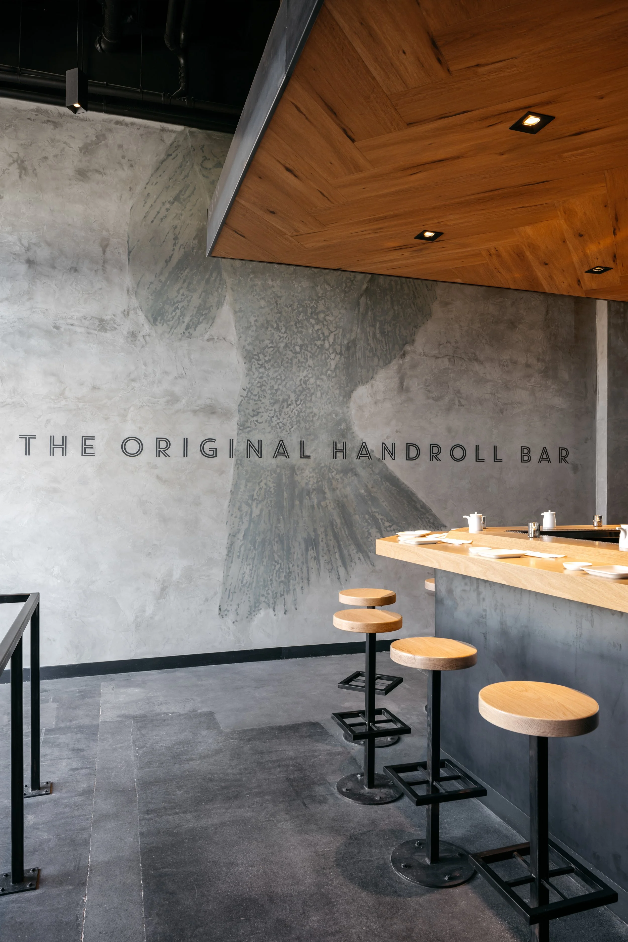 Architecture of KazuNori handroll bar in Chapman Market, Koreatown, plaster wall with etching and seating