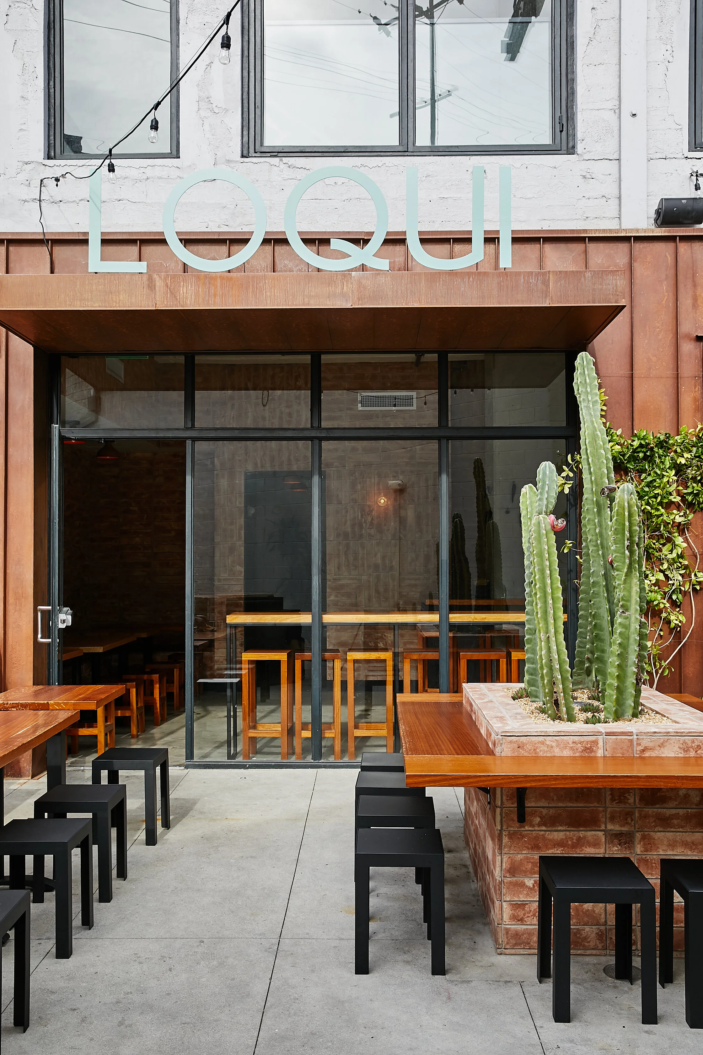 Architecture of Loqui restaurant in downtown Los Angeles, patio seating and signage