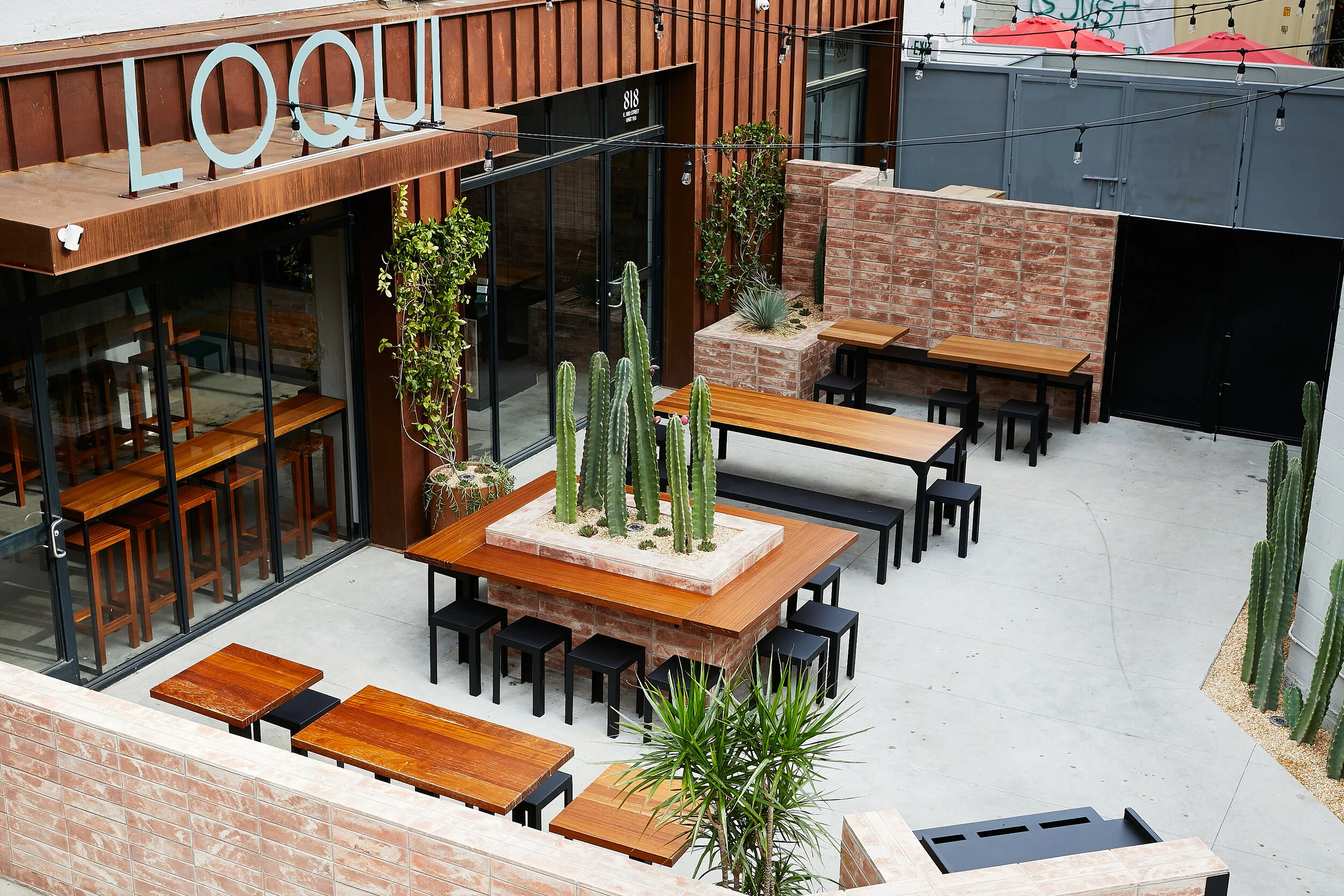 Architecture of Loqui restaurant in downtown Los Angeles, arial view of patio seating and signage