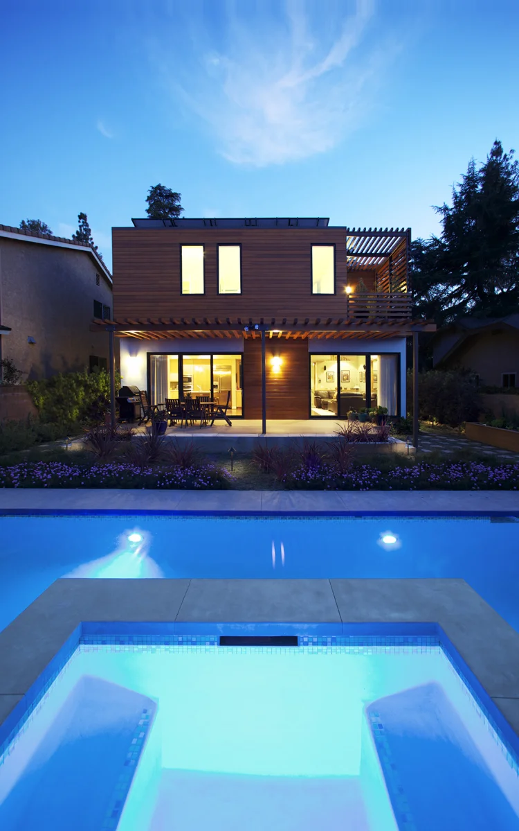 Architecture of Energy Star and Build it Green residence with wet garden and xeriscape garden, view from pool at night