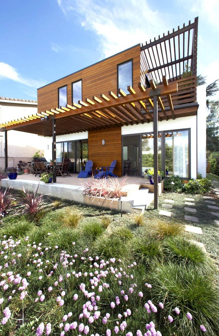 Architecture of Energy Star and Build it Green residence with wet garden and xeriscape garden, backyard view