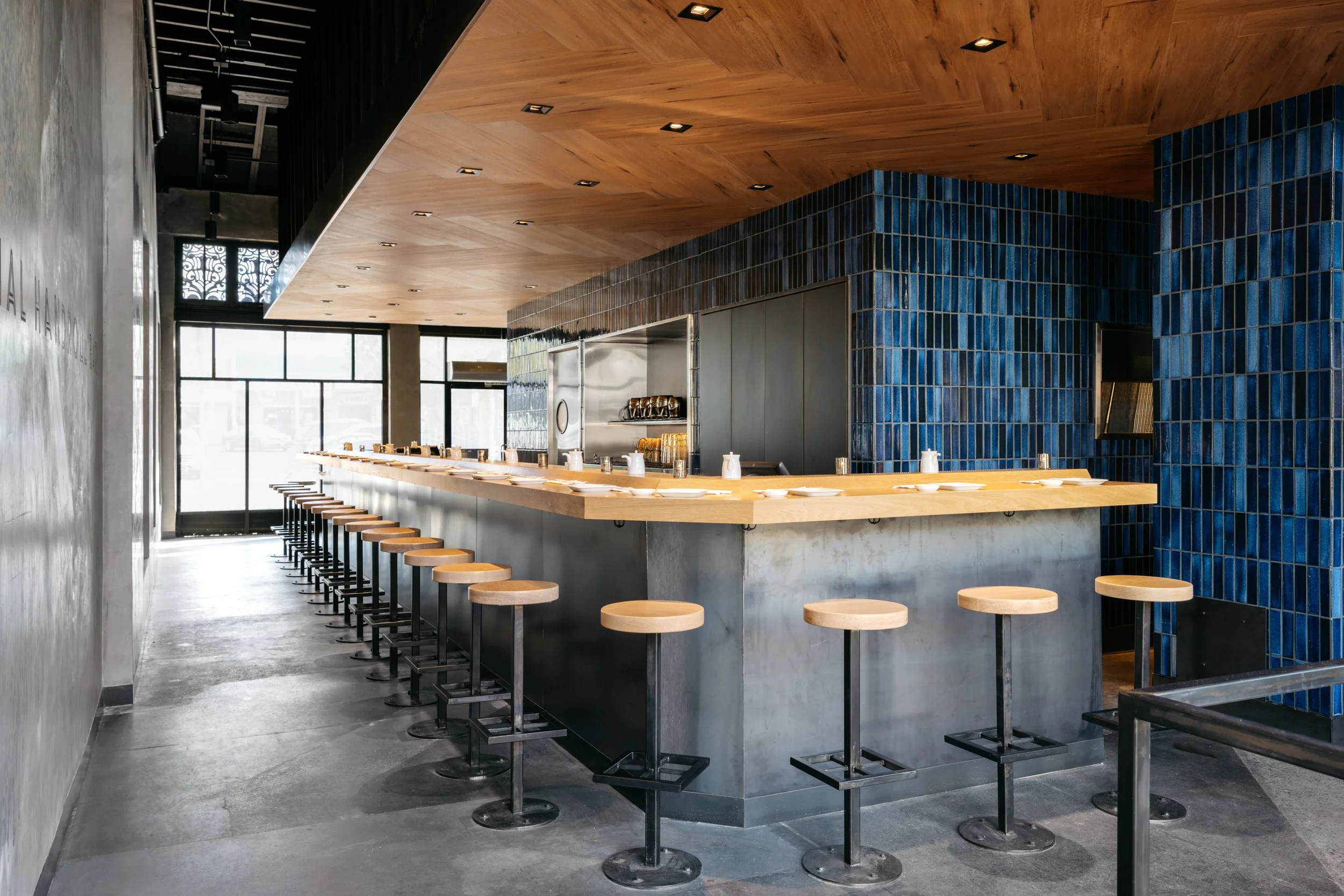 Architecture of KazuNori handroll bar in Chapman Market, Koreatown, C shaped bar with seating, blue tile