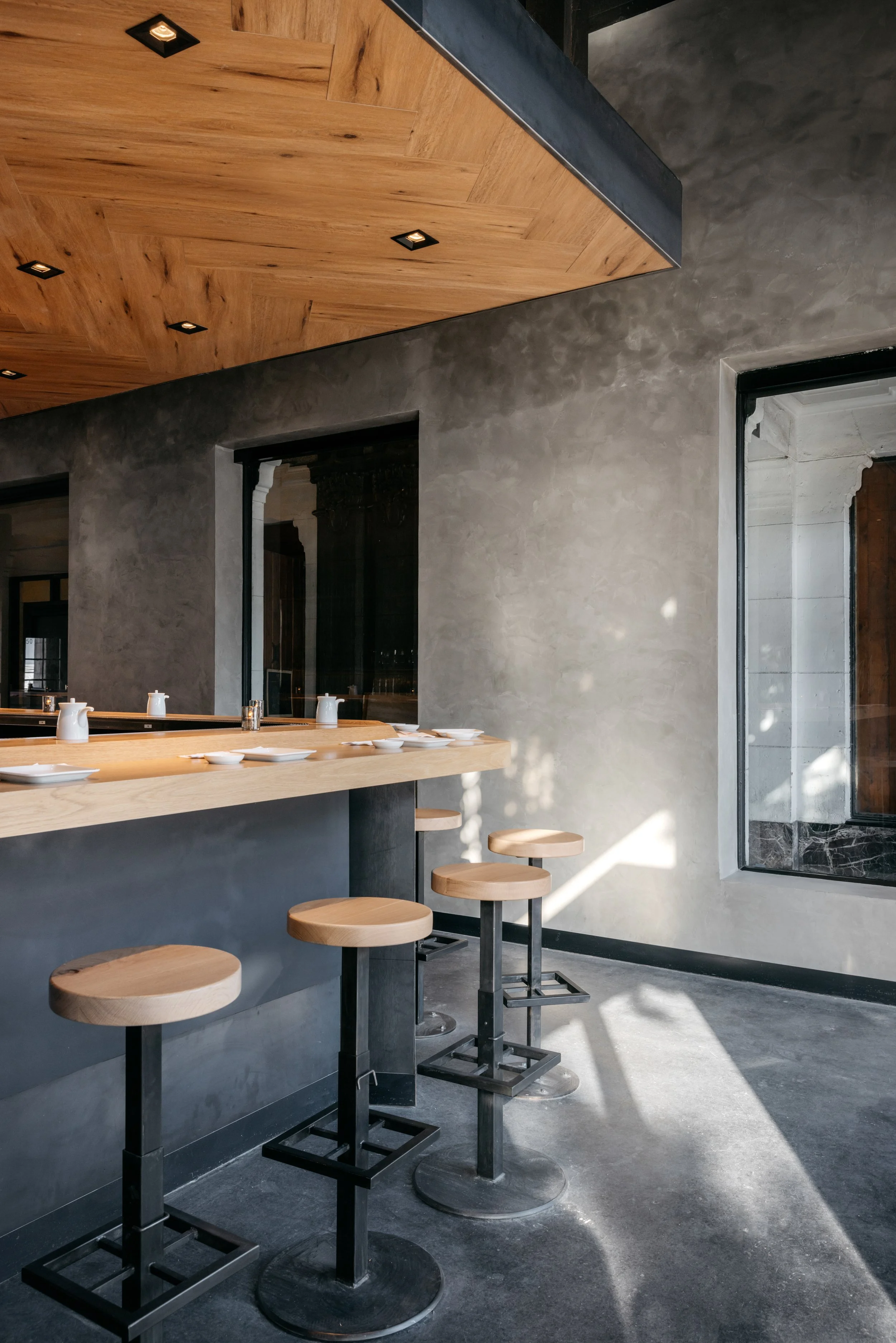 Architecture of KazuNori handroll bar in Chapman Market, Koreatown, concrete, plaster and wood details