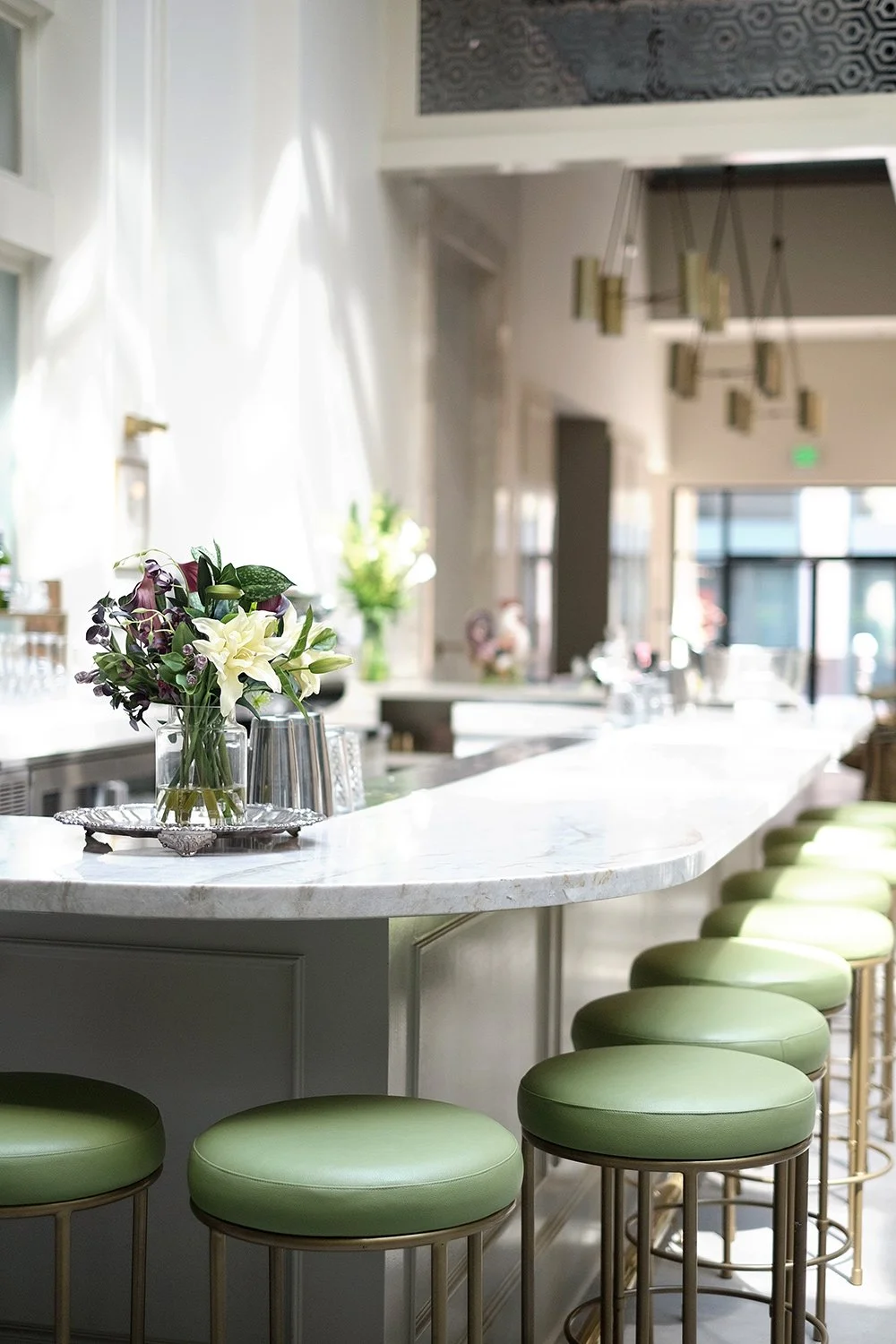 Architecture of Spring restaurant, downtown Los Angeles, bar seating with green and brass stools