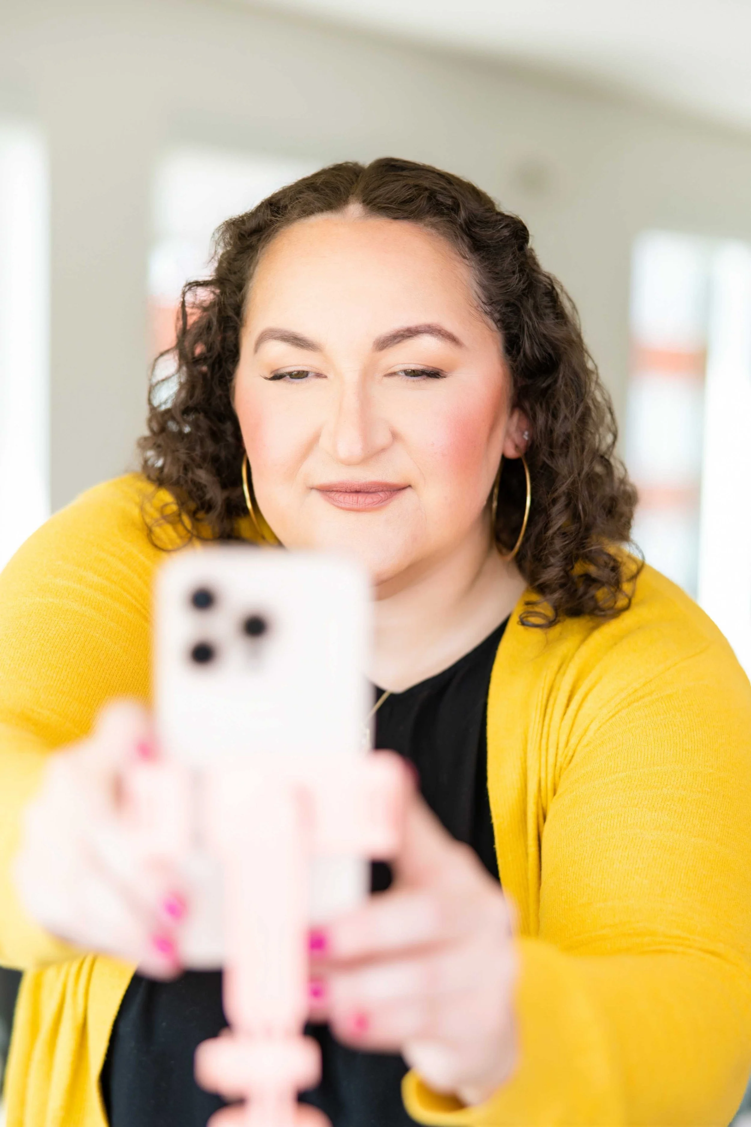 Golden Poppy Digital Owner Tori looking at a phone.