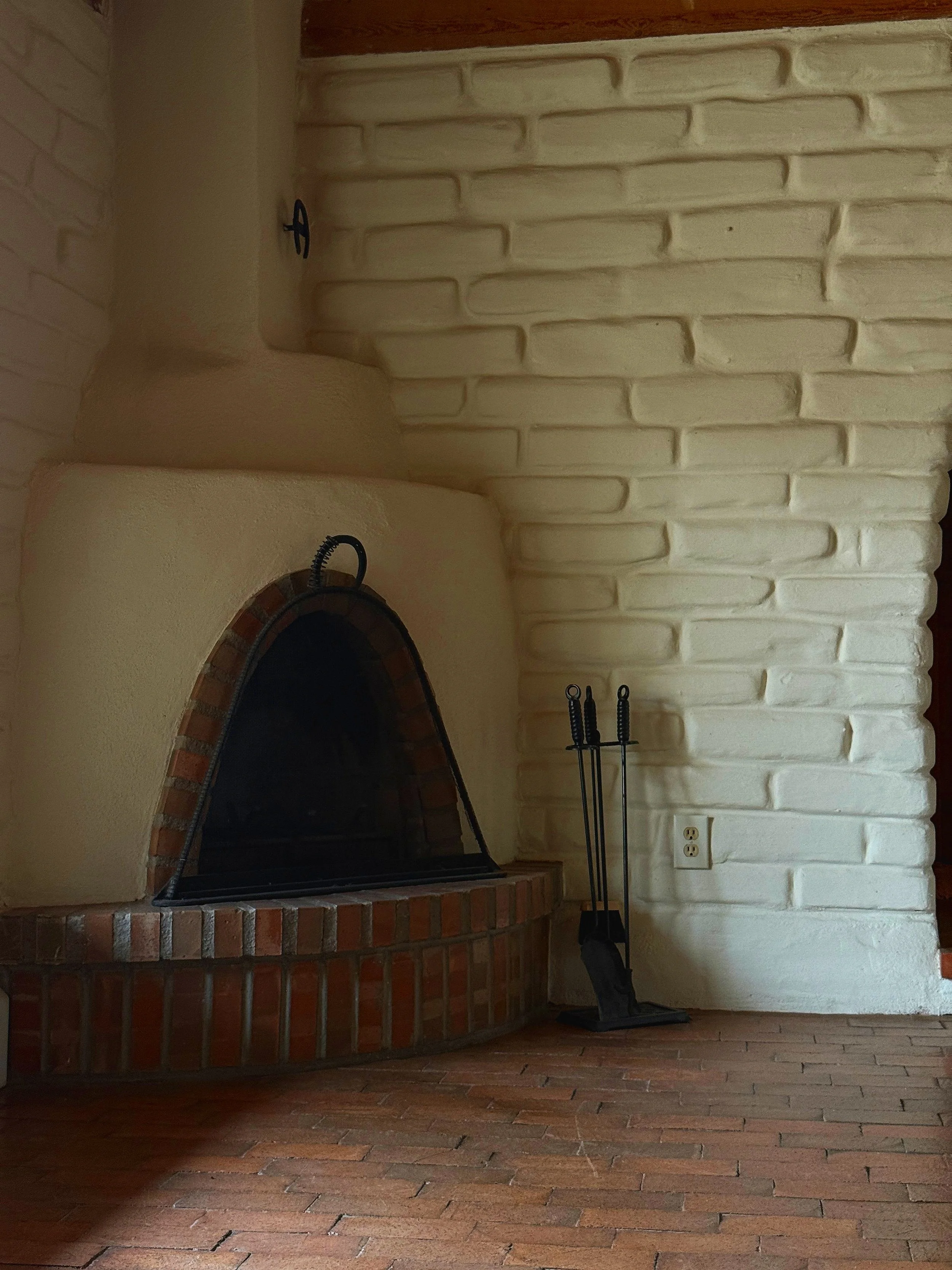 New Mexico Fireplace with a brick surrounding and brick floors - Nadia Mousleh Real Estate