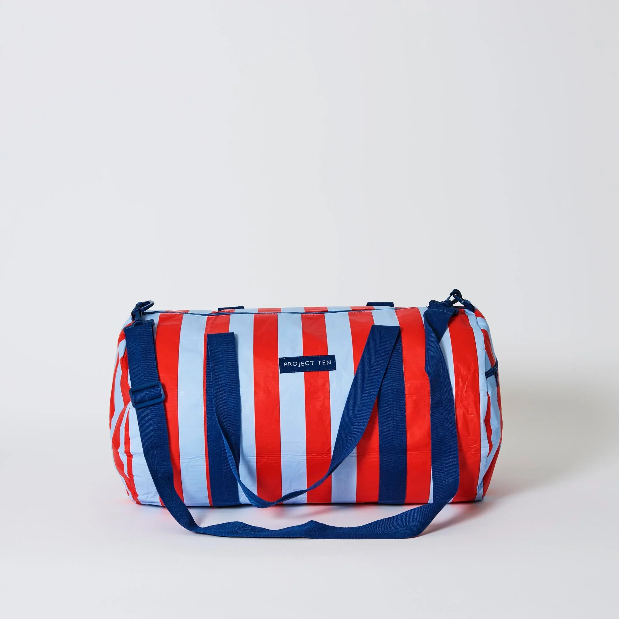 ProjectTen_BarrelBag_RedBlueStripe1.webp