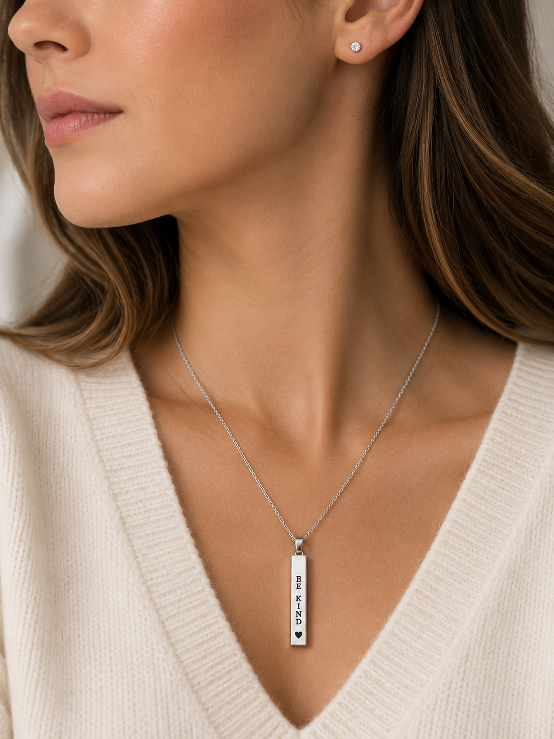 Aunt Nut's Tiny Reminders Collection featuring engraved stainless steel affirmation necklaces in gold and silver with encouraging words for confidence, kindness, resilience, and self-love.