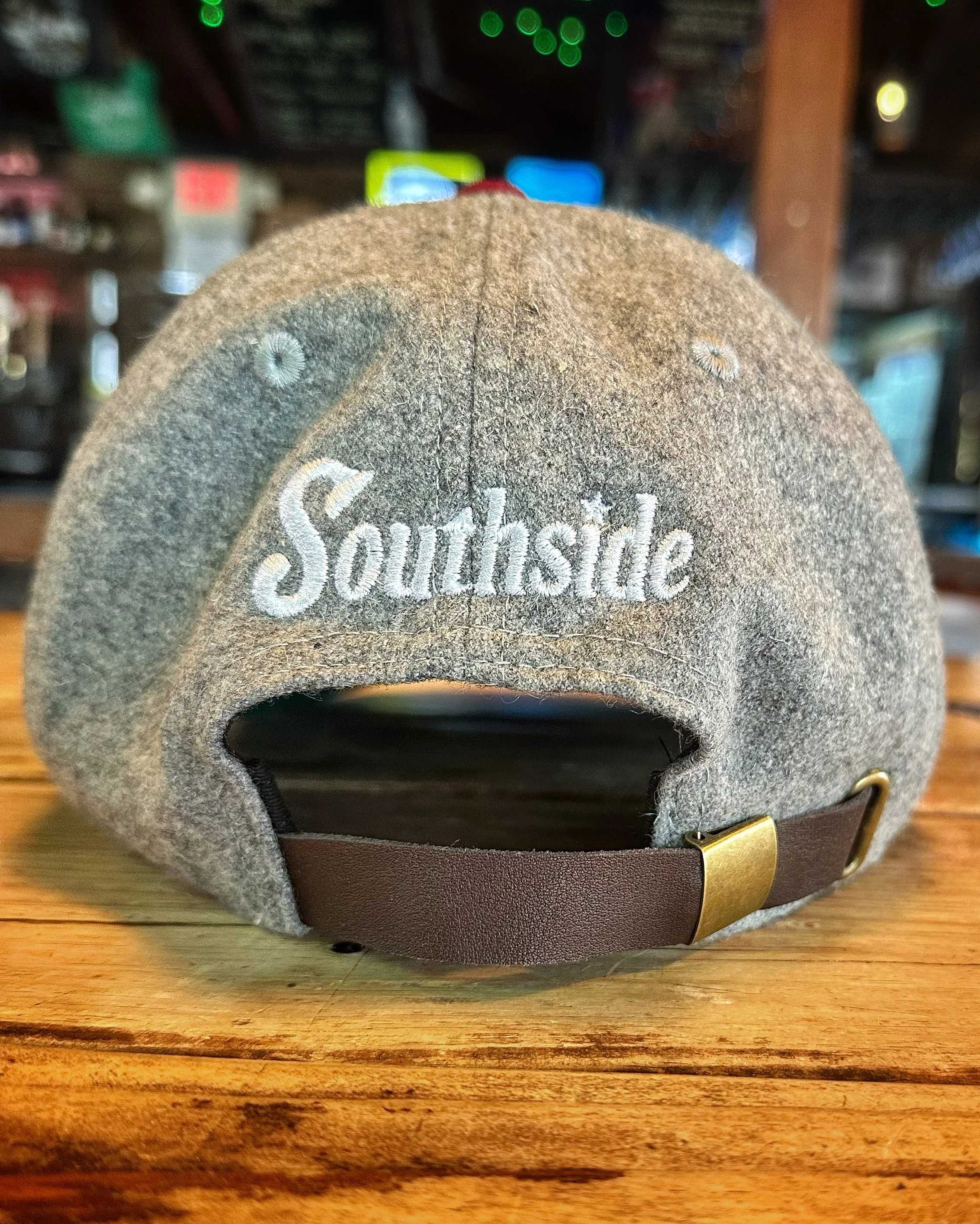 Back view of grey Southside Heritage wool golf hat with leather strap and brass clasp