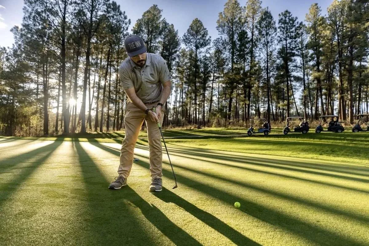 Golfer putting on a green during a golf lesson in Austin, Texas