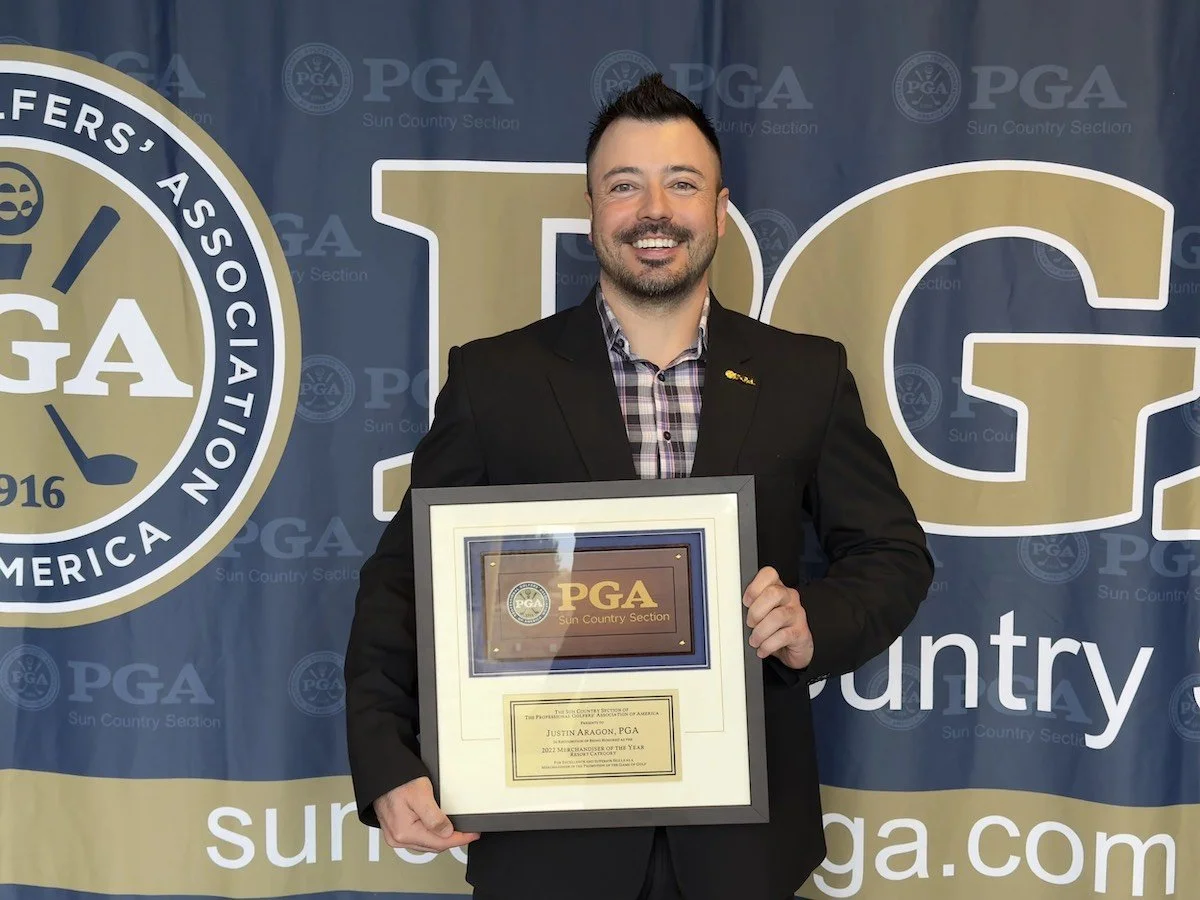 Justin Aragon PGA professional holding award for golf instruction achievement