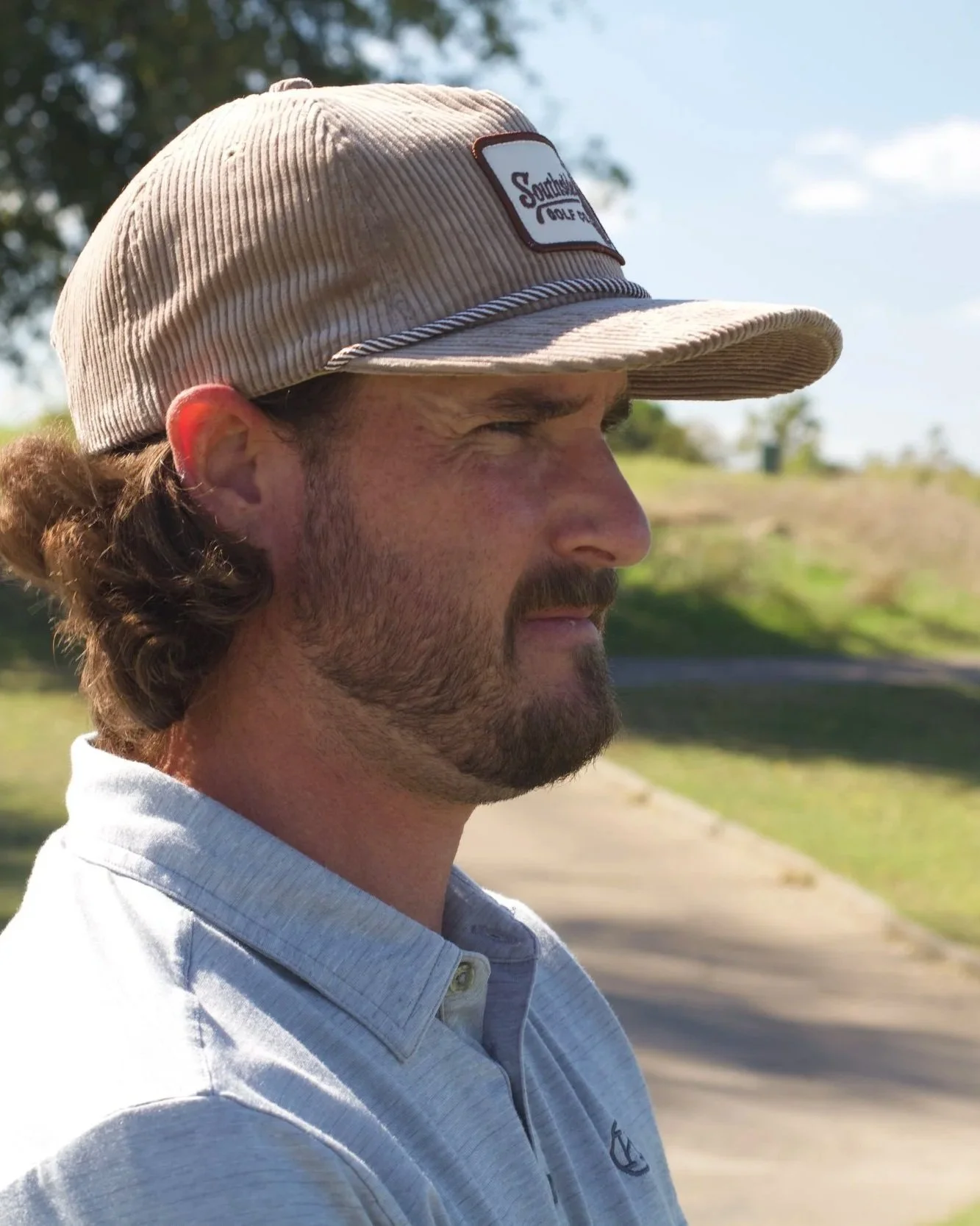 Brown corduroy Southside golf hat worn by a golfer in Austin