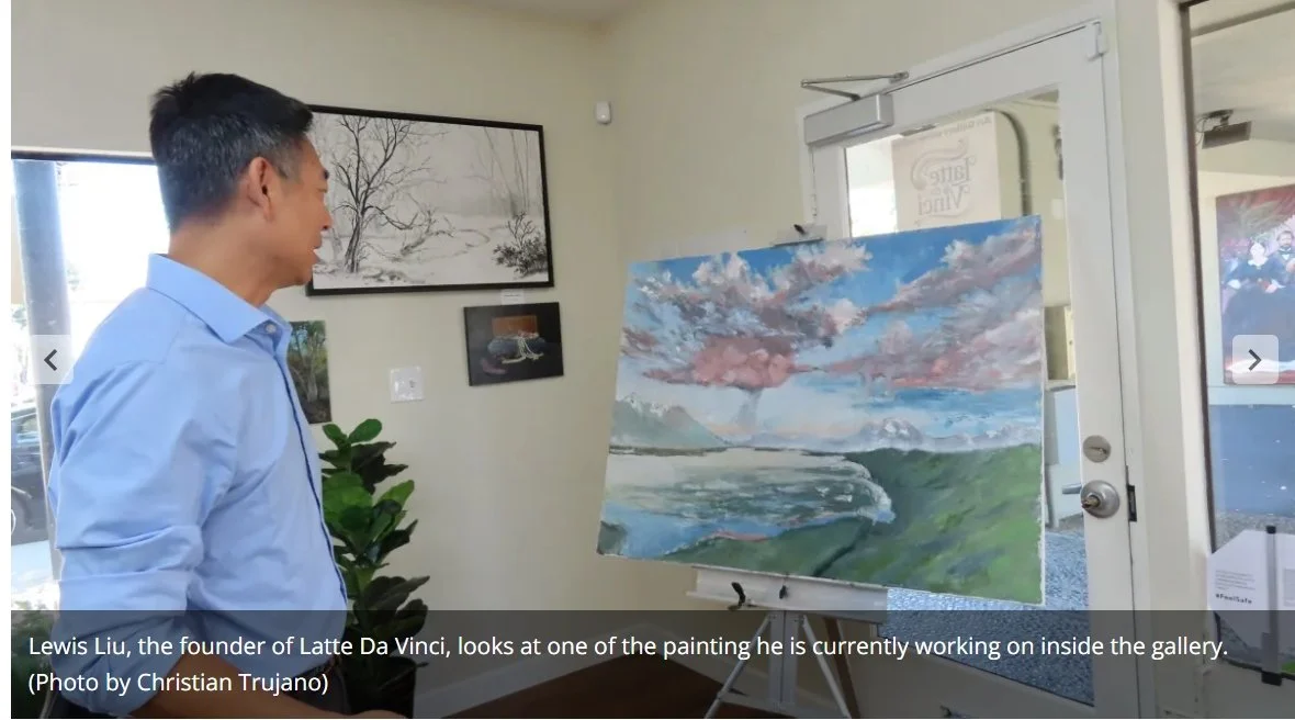 Lewis Liu looking at a painting of his own in new gallery Latte Da Vinci