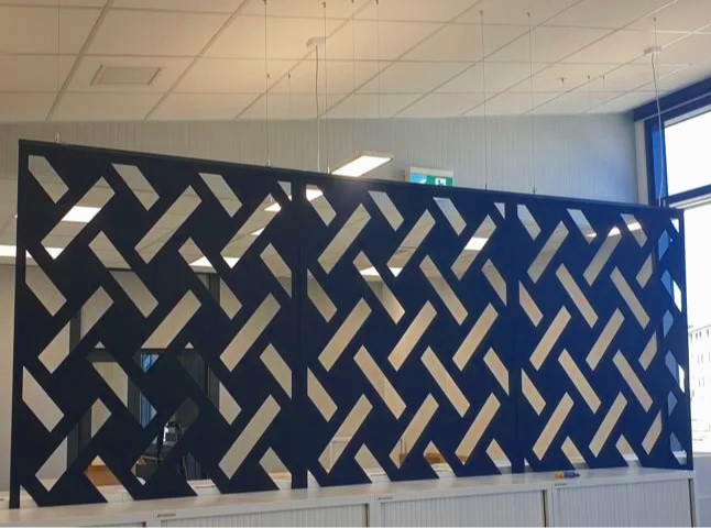 Interior of an office with a decorative black and white patterned partition wall.