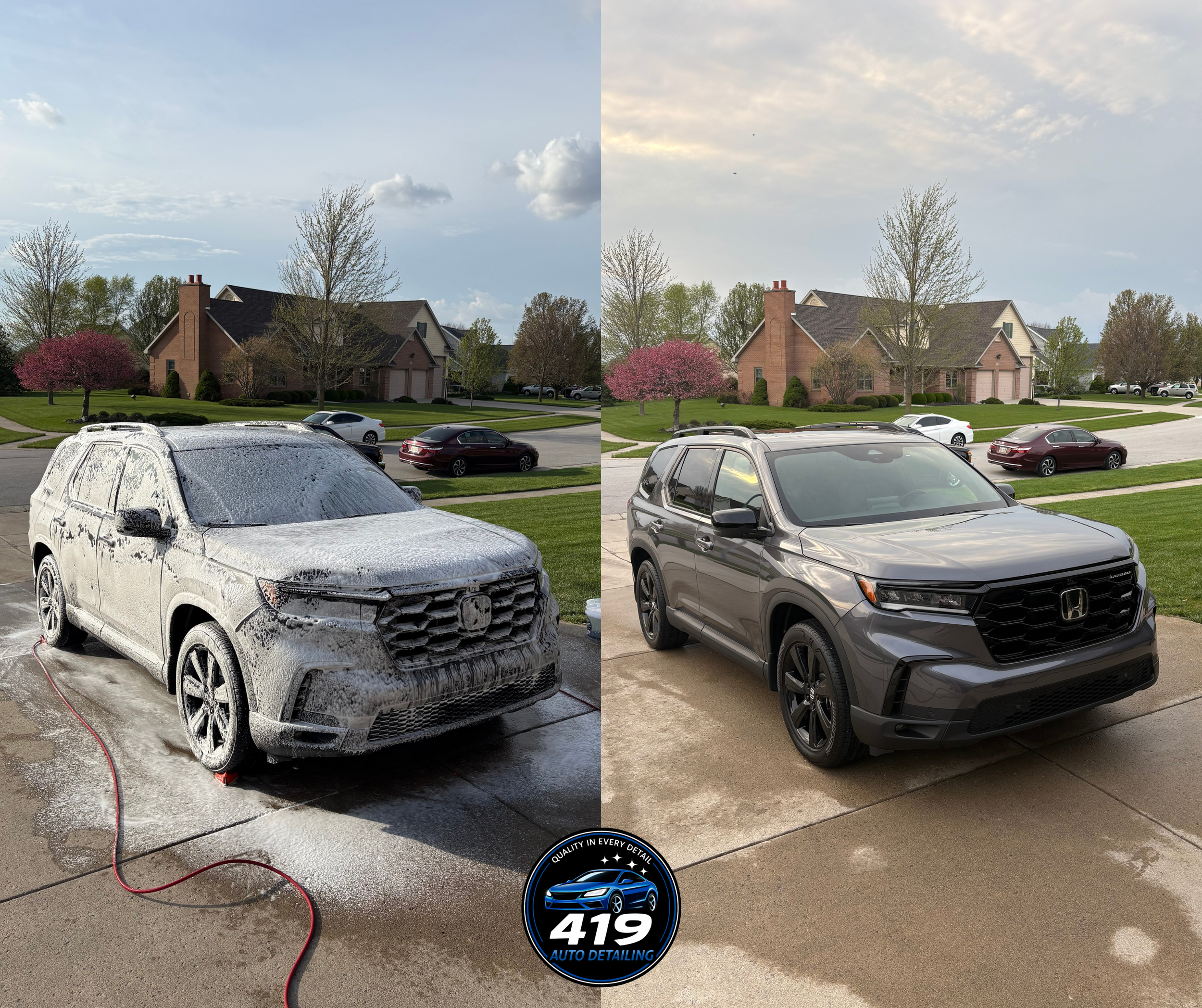 Front of a white SUV covered in soap and foam during a car wash, with a black and blue auto detailing logo at the bottom. Residential neighborhood with houses, trees, and parked cars in the background.