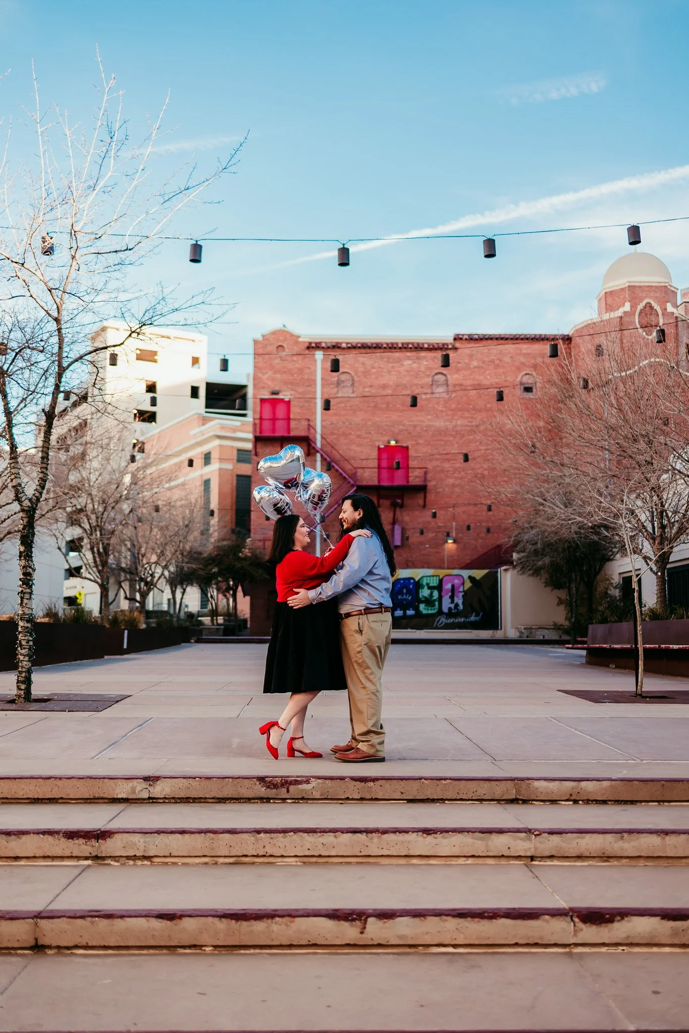 Couple sharing a kiss on the downtown El Paso steps during an engagement session.