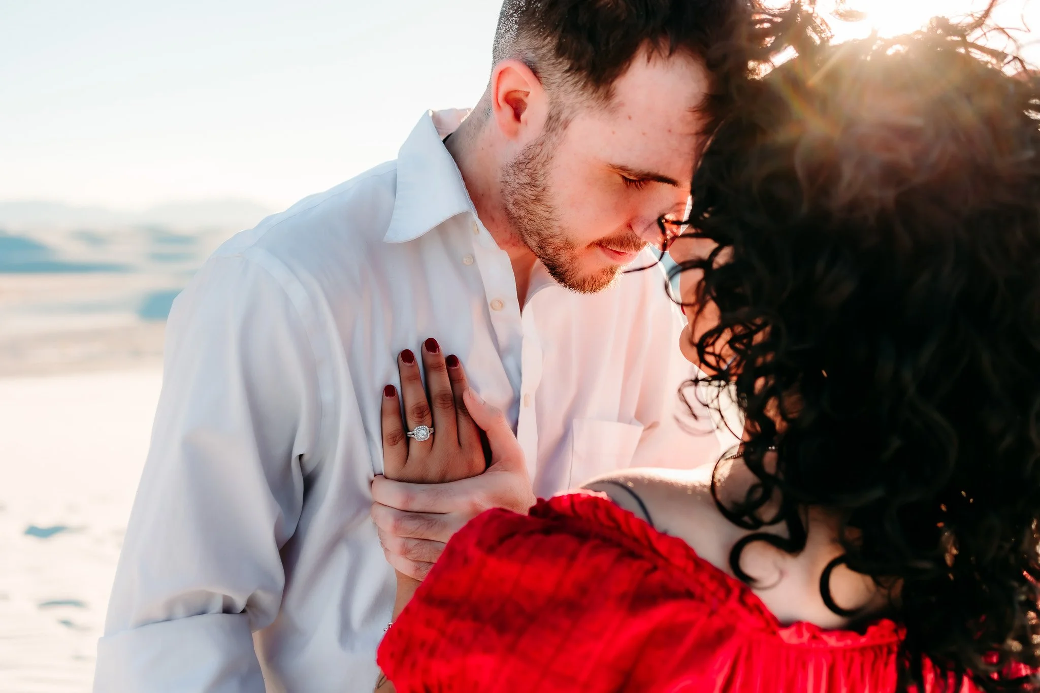 Close-up of an engaged couple sharing an intimate moment during their White Sands National Park engagement session in New Mexico.