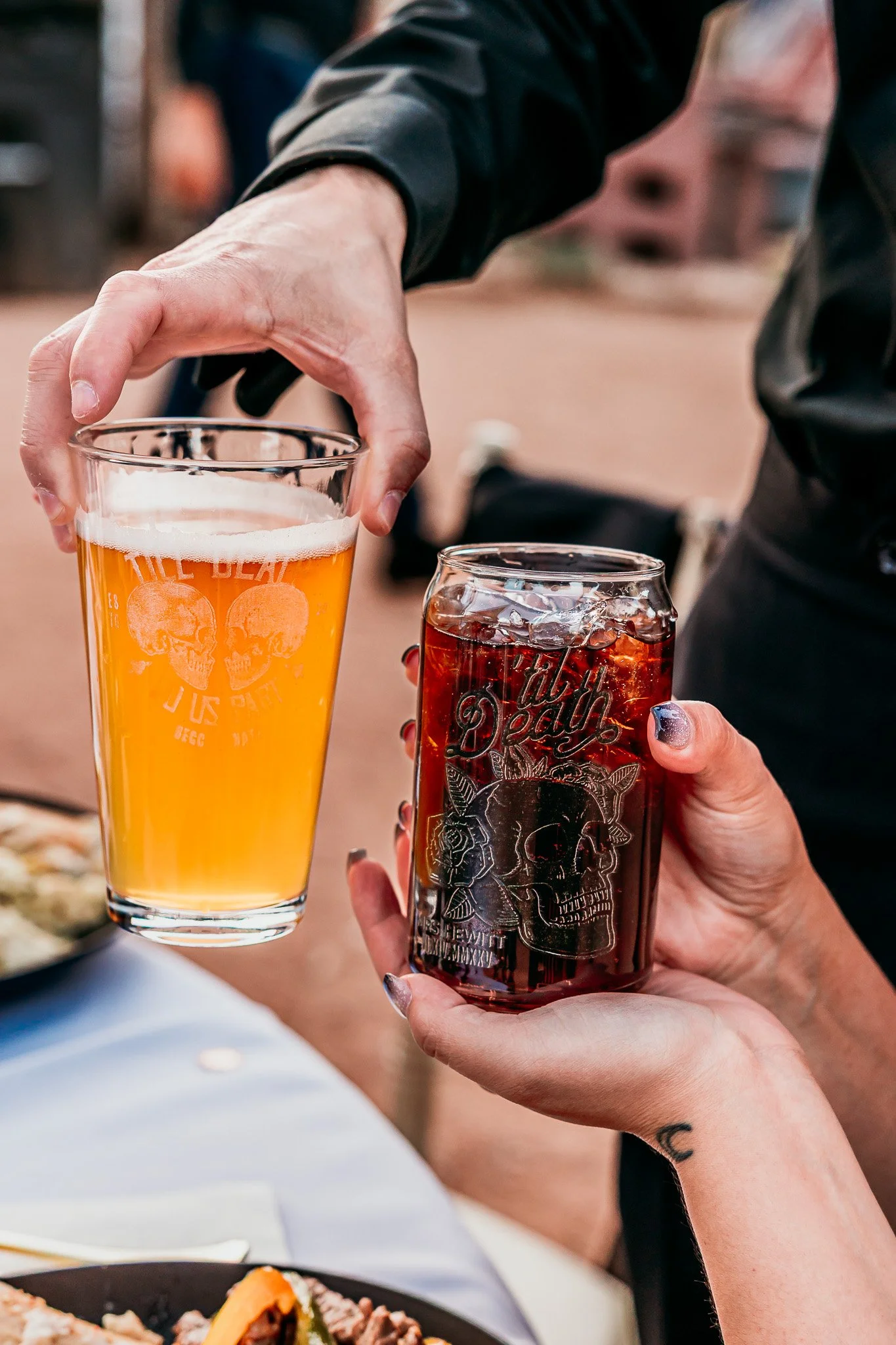 Guests holding craft beer and cocktails during the outdoor reception at an intimate wedding at The Mystic in Santa Fe.