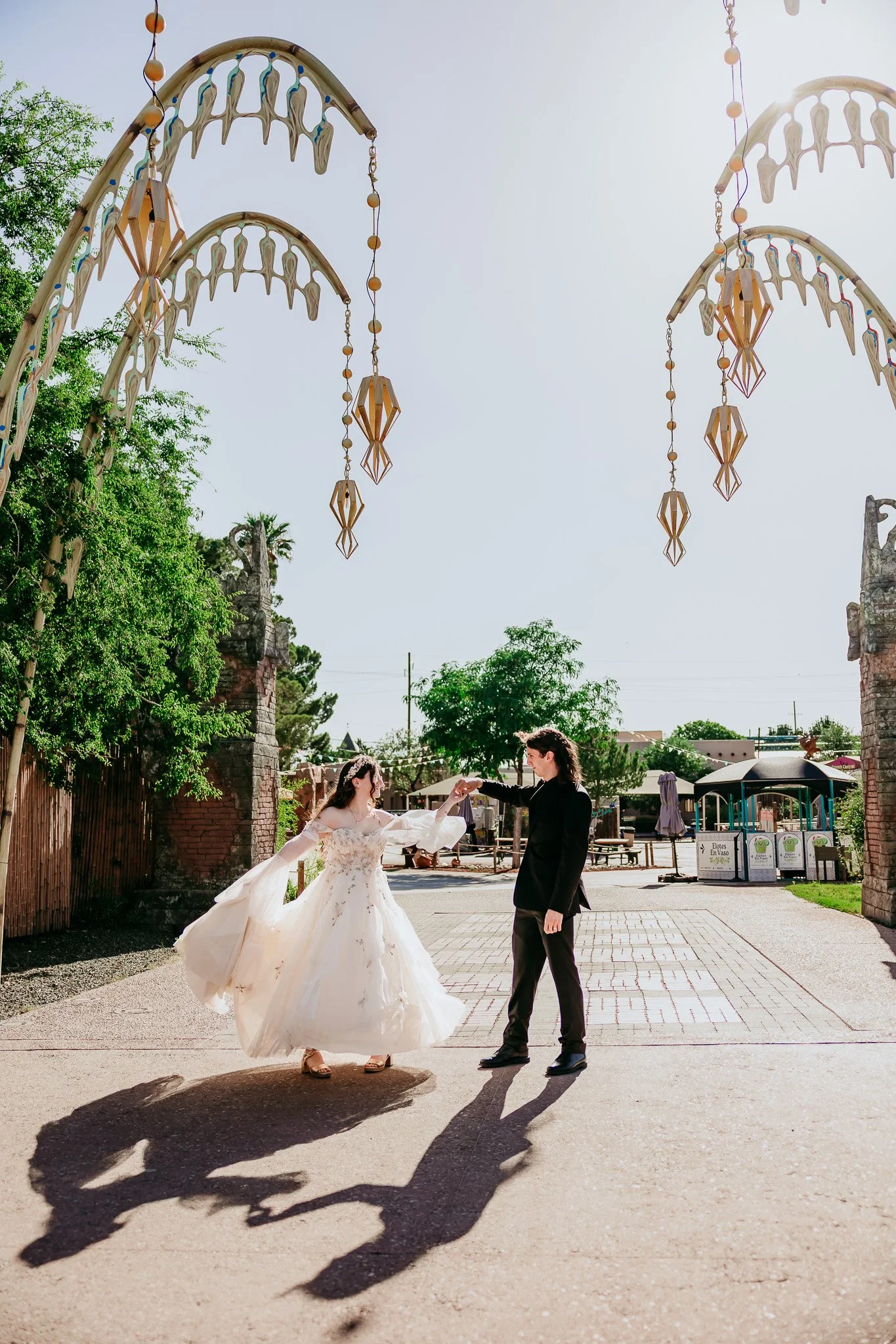 Newlyweds dancing and spinning together during their El Paso Zoo wedding in El Paso, Texas.