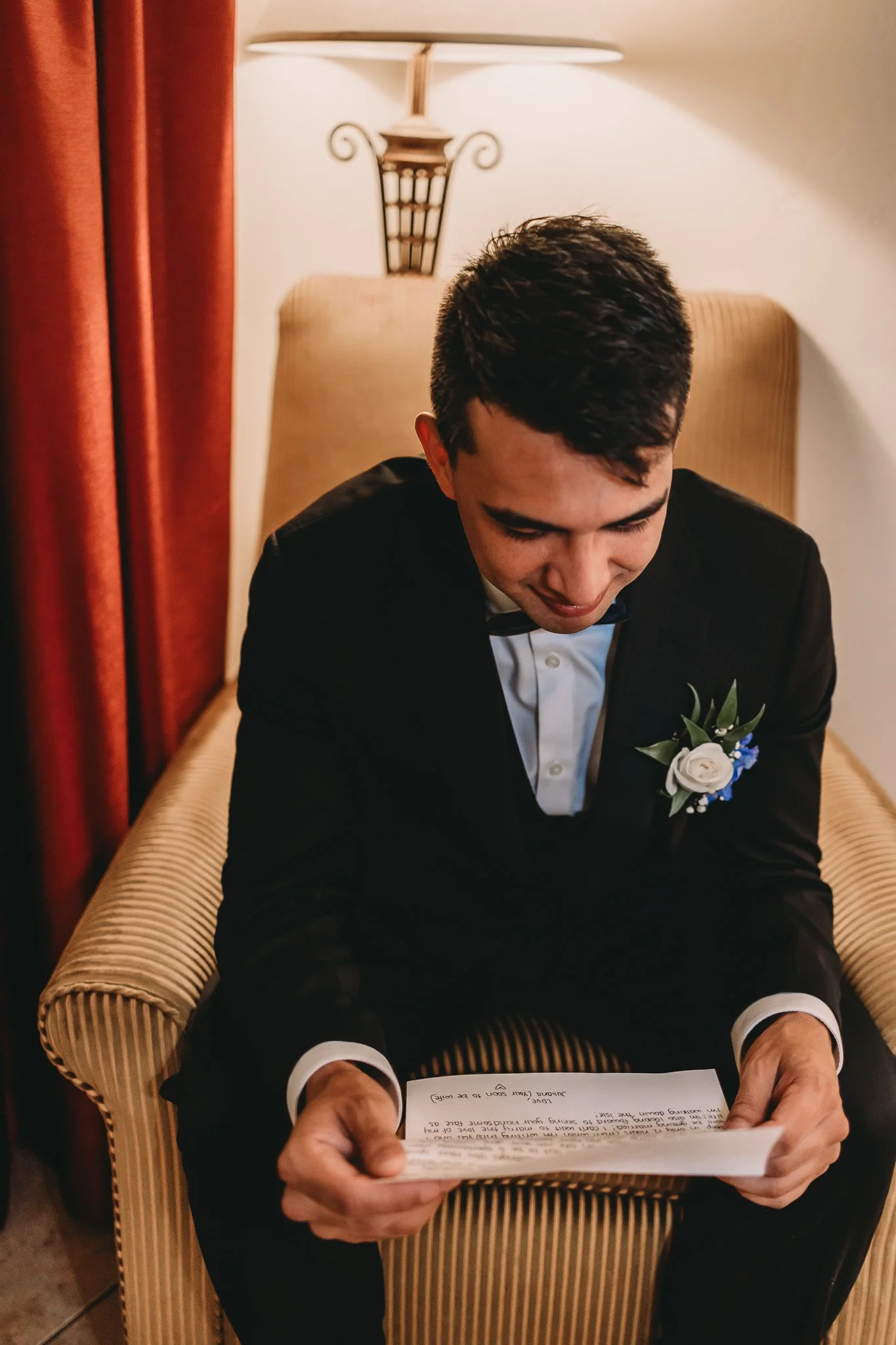 Groom reading a private note from bride before ceremony