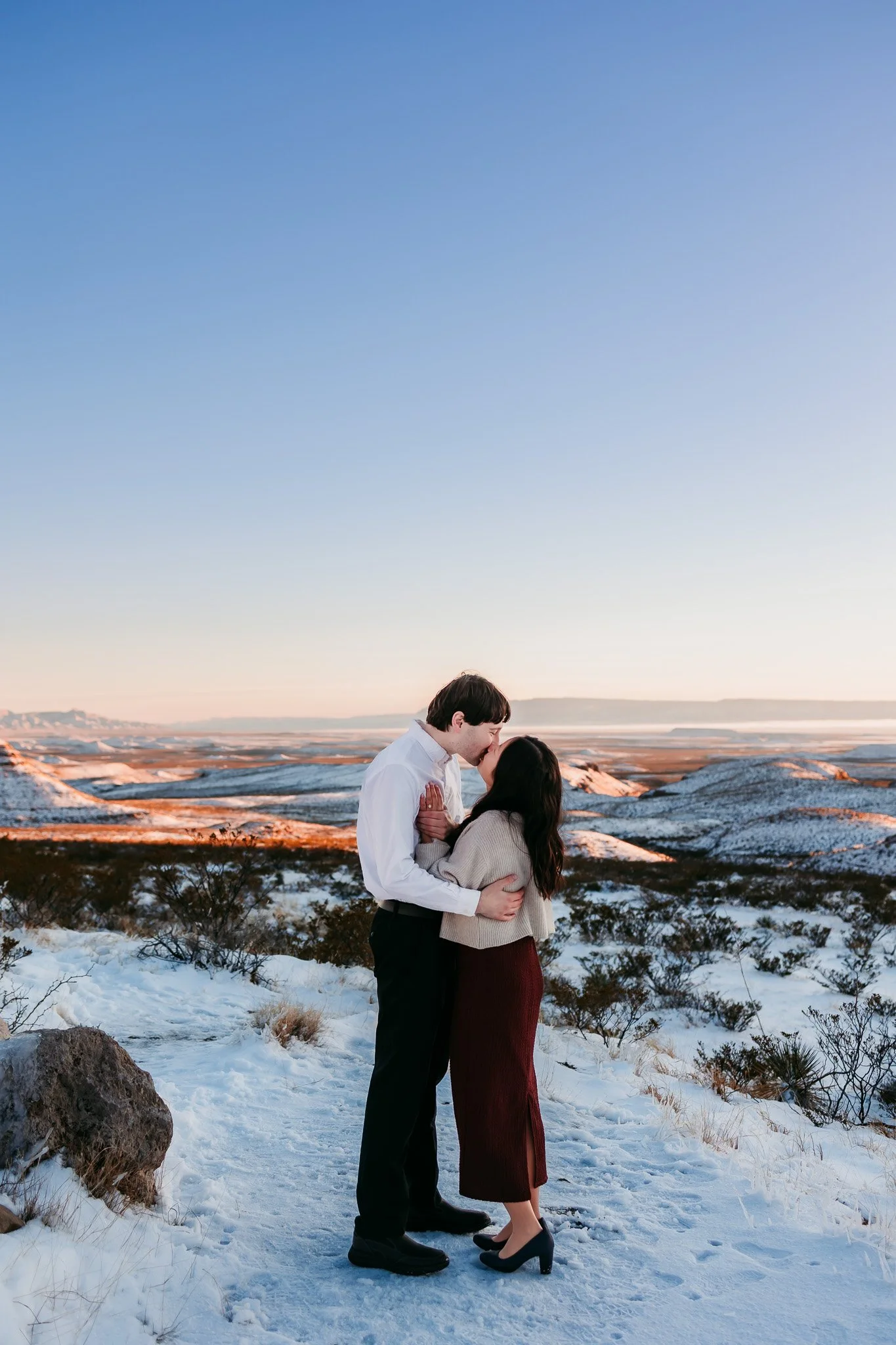 Romantic engagement portrait of a newly engaged couple surrounded by the dramatic Guadalupe Mountains landscape near Carlsbad, New Mexico.