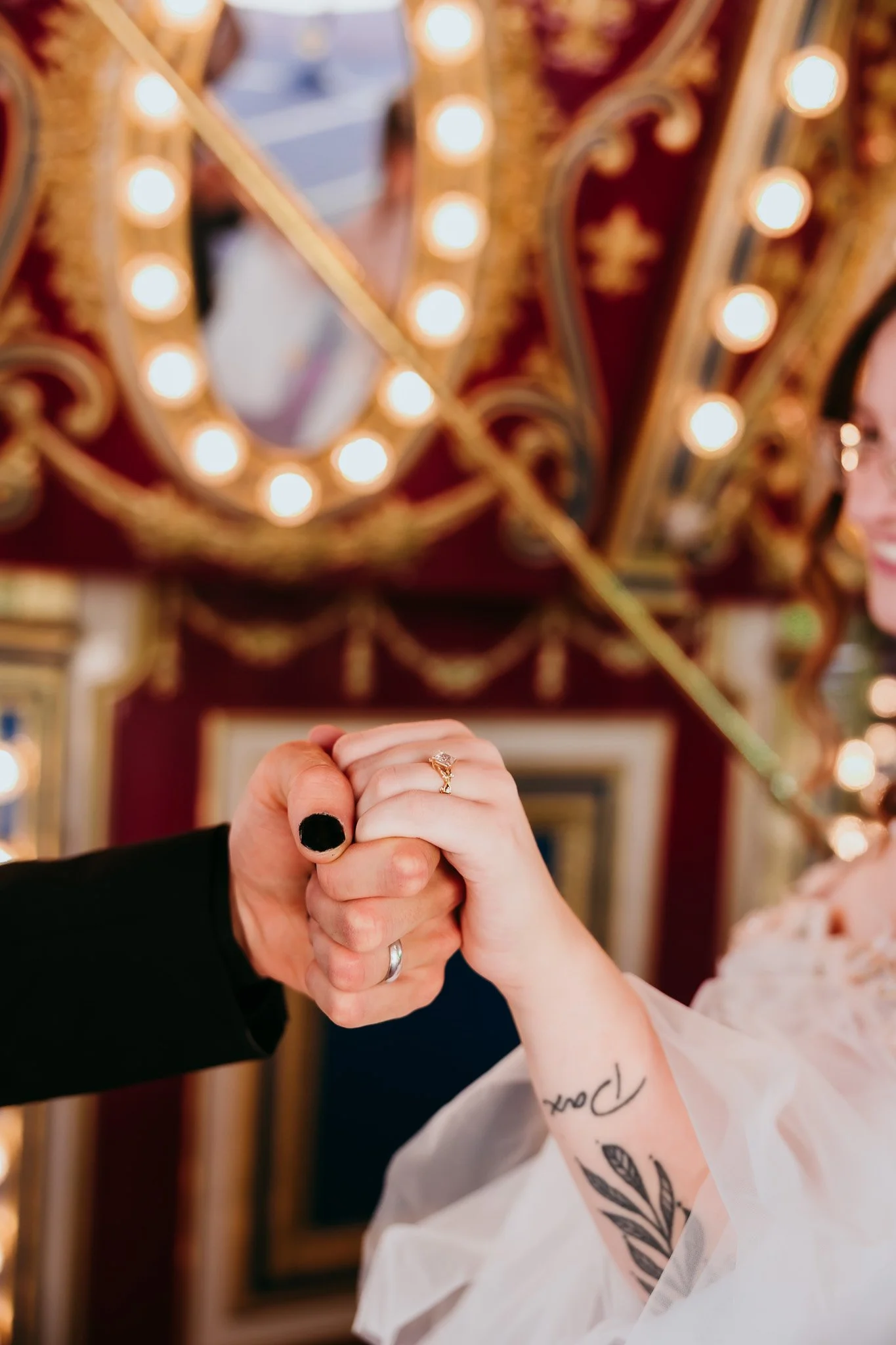 Close-up of newlyweds' rings as they hold hands on the carousel at the El Paso Zoo in El Paso, Texas.