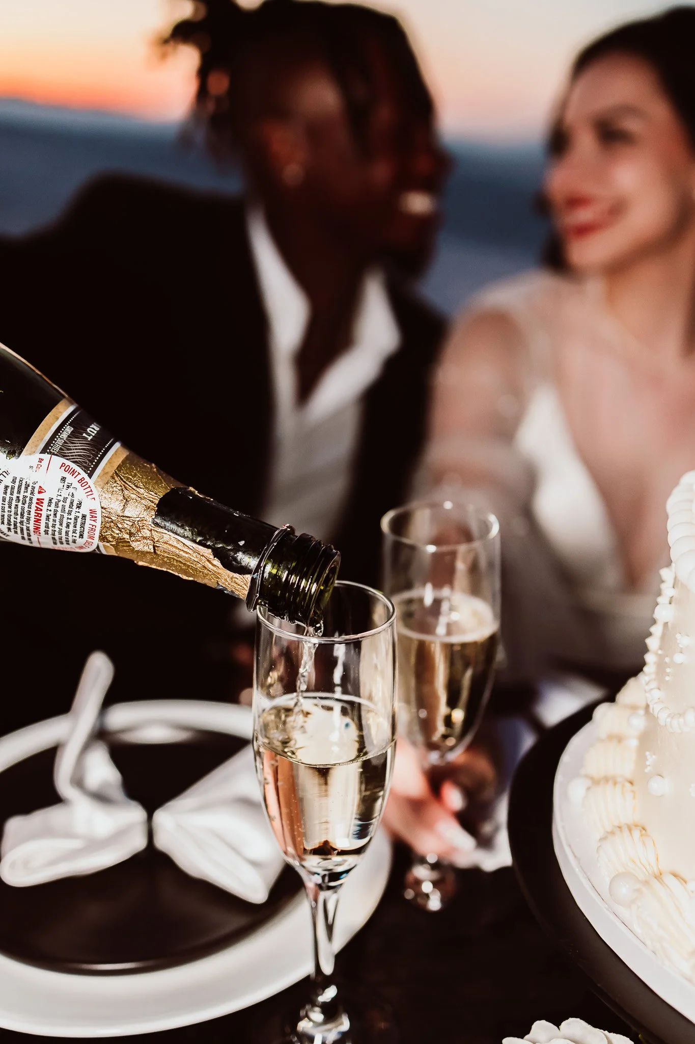 Champagne being poured into glasses during an intimate post-elopement celebration at White Sands National Park in New Mexico.