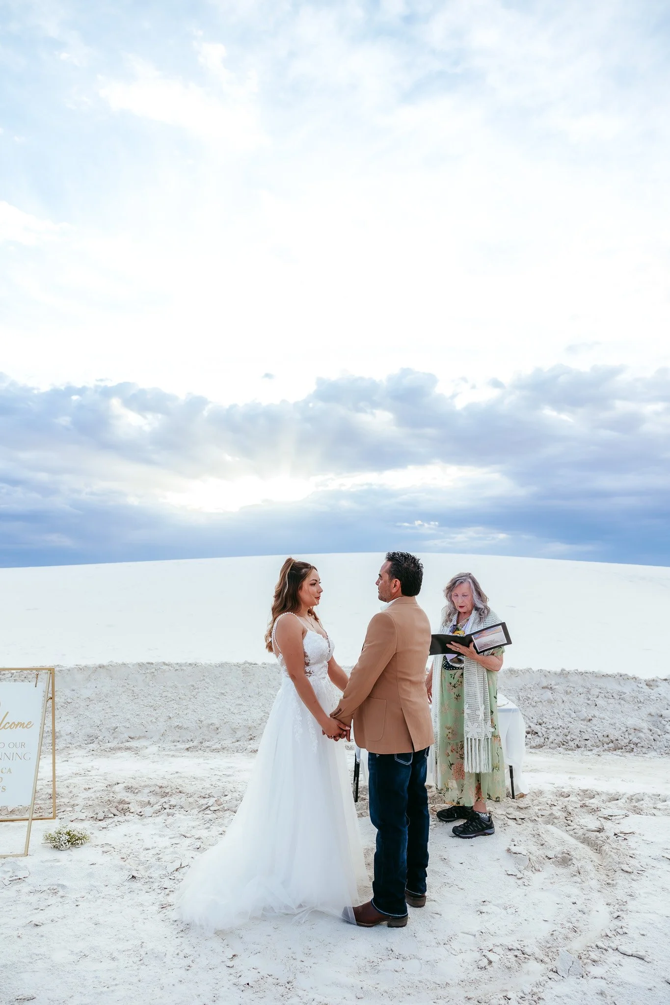 Bride and groom during their White Sands National Park elopement ceremony in New Mexico with a sunset backdrop.