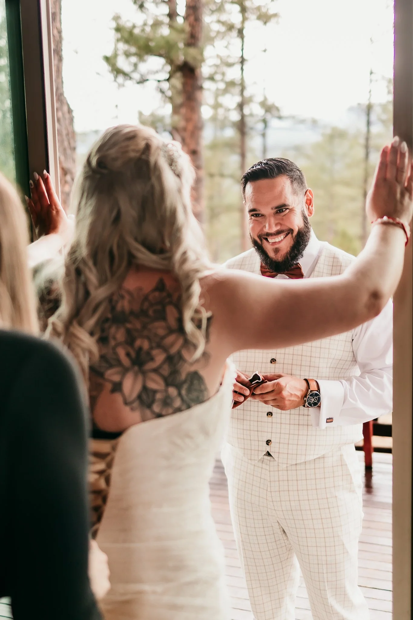 Groom smiling at his bride during first look