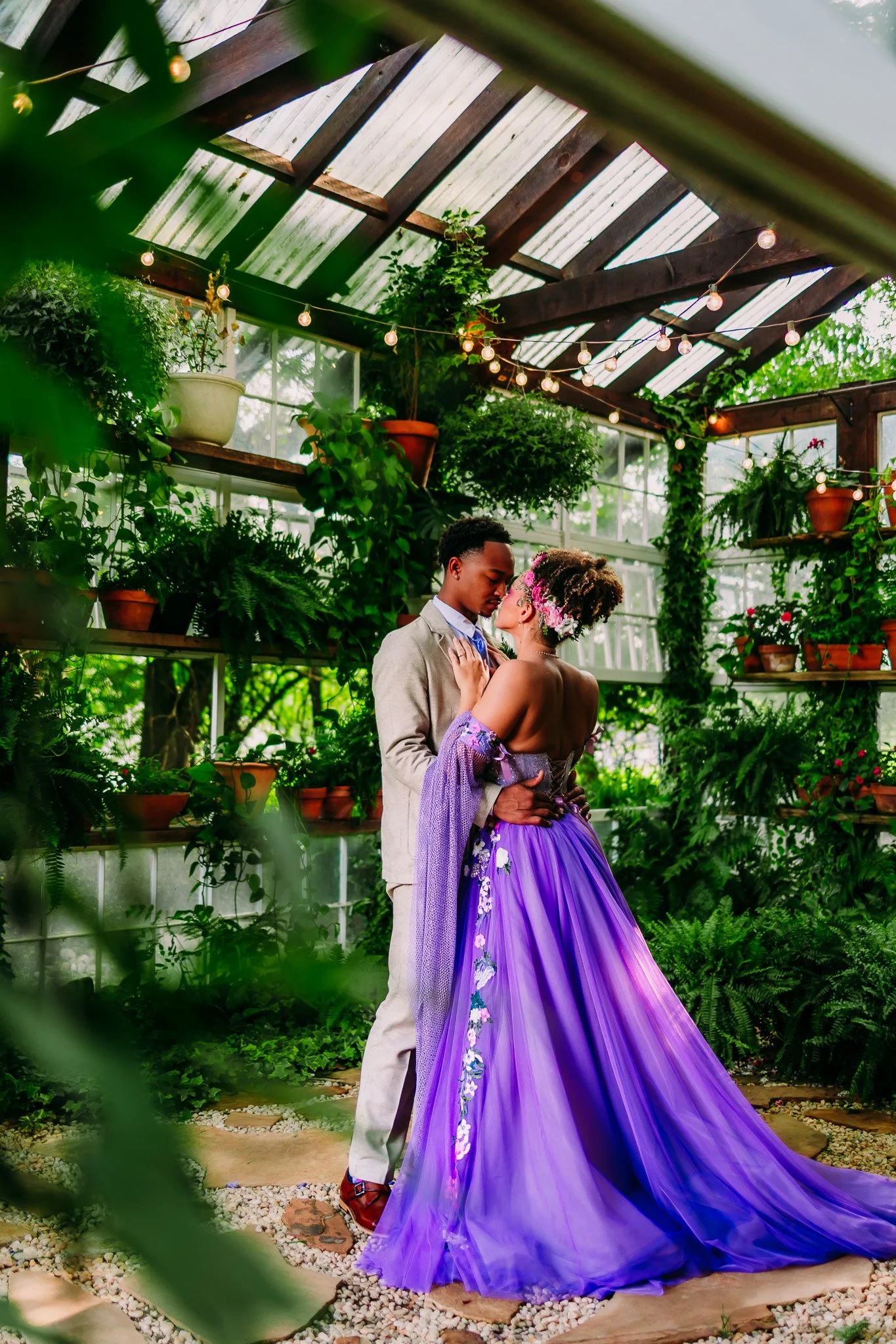 Couple sharing a romantic kiss inside the greenhouse during their intimate elopement at The Vaughn House in Forest, Virginia.