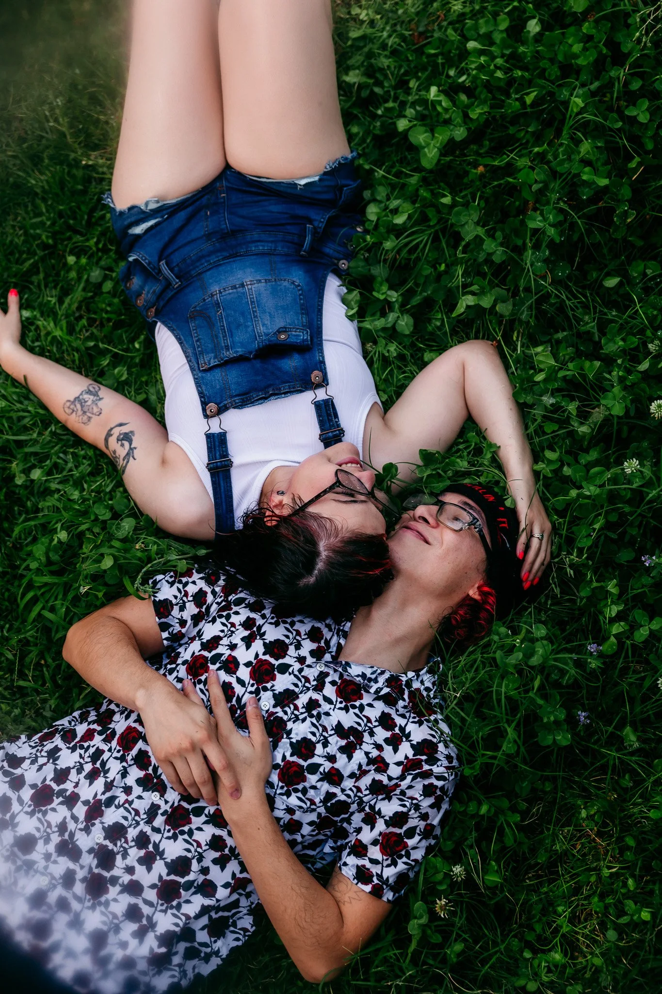 Partners relaxing together on the grass during a cozy lifestyle couples photography session at home in Las Cruces, New Mexico.