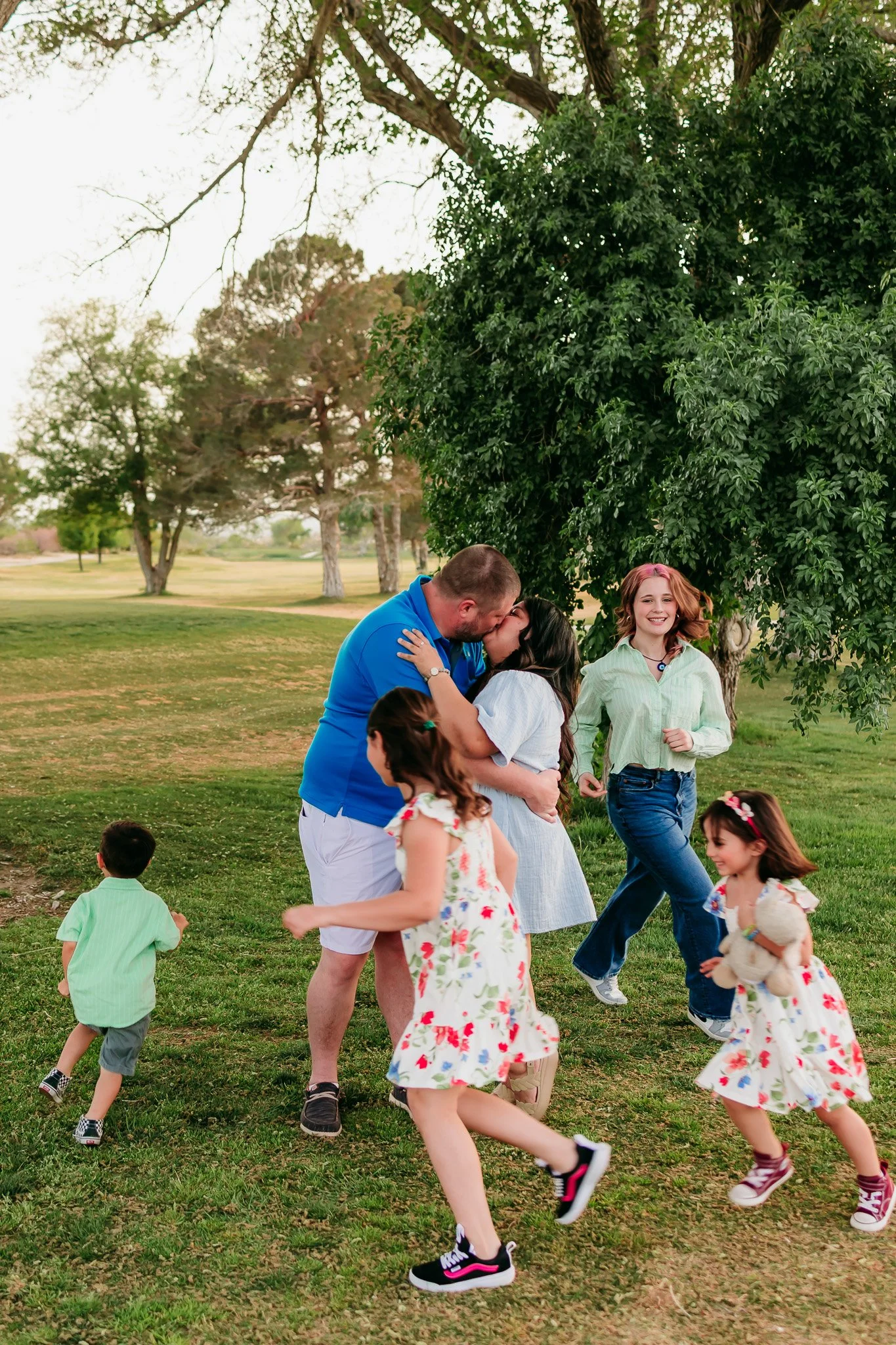 Parents playing with their children during a fun-filled family photography session in Las Cruces, New Mexico.