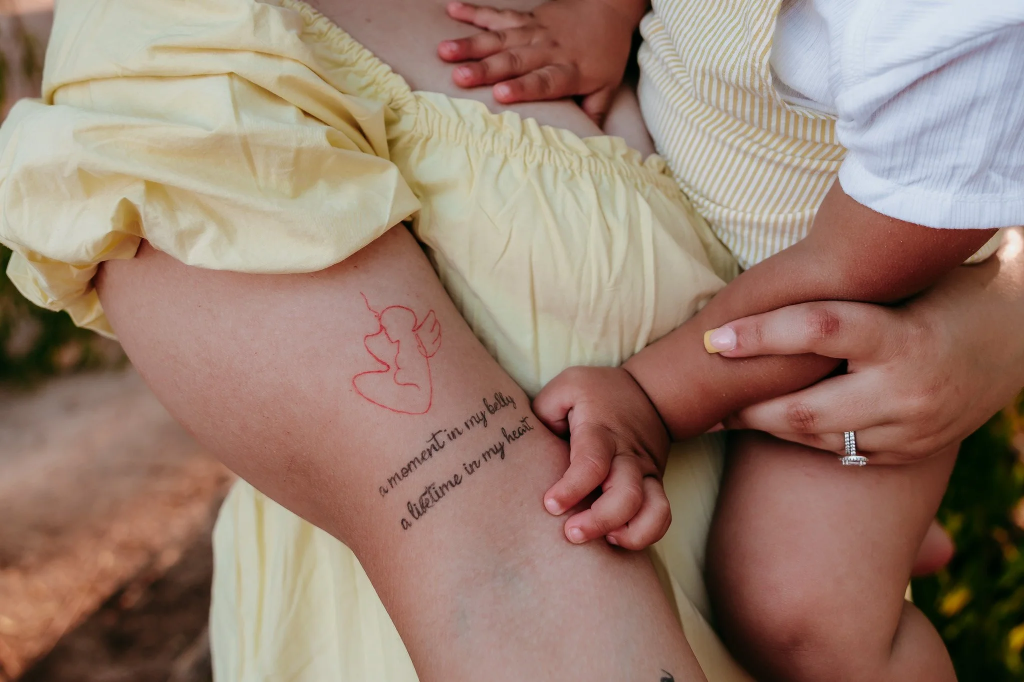 Close-up of a meaningful family tattoo while a child holds their parent's hand during a lifestyle family photography session in La Mesa, New Mexico.