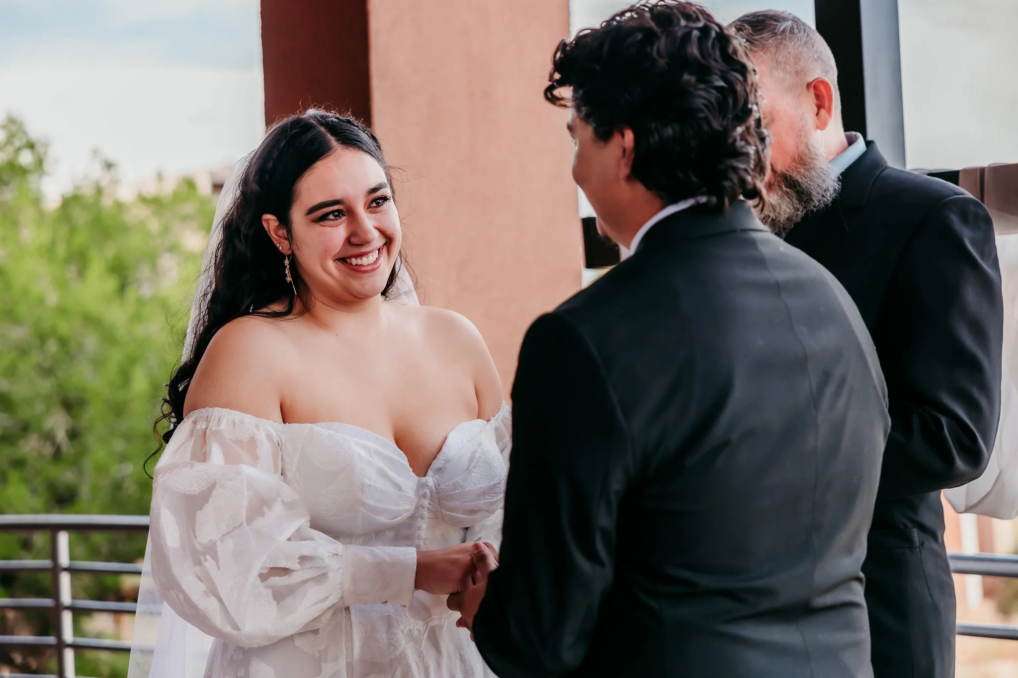 Bride smiling at groom with happy tears