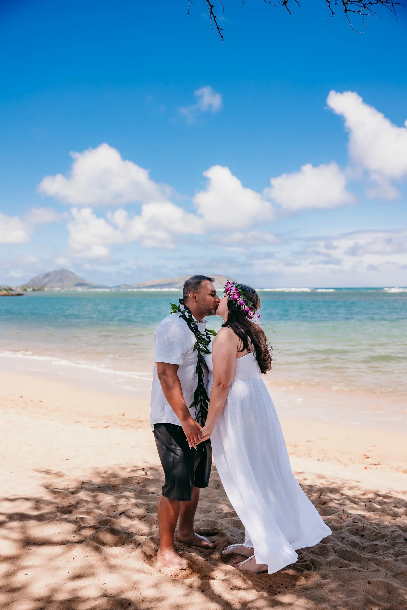 Couple kissing on the beach in Honolulu Hawaii wedding photographer