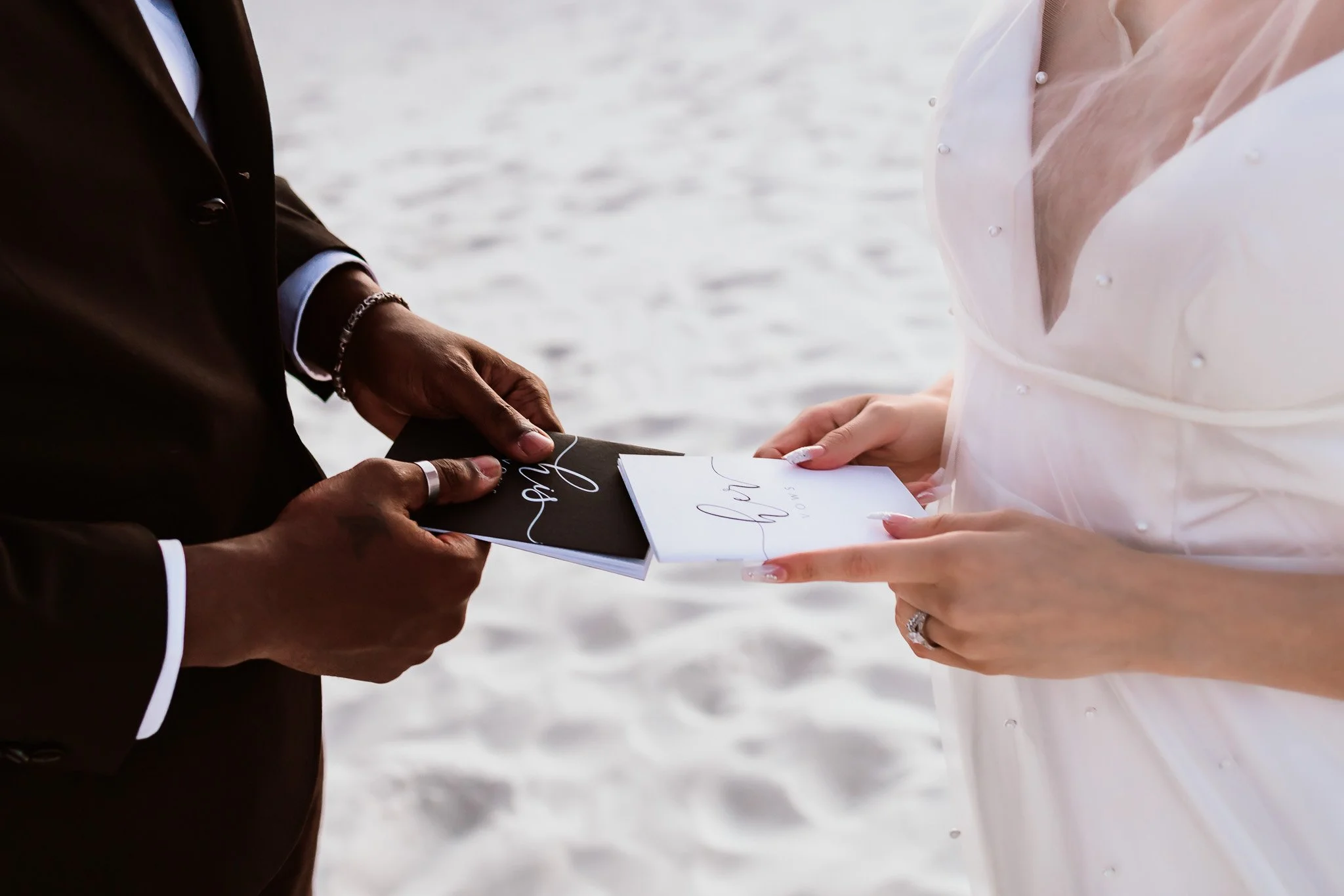 Bride and groom holding his and hers vow books