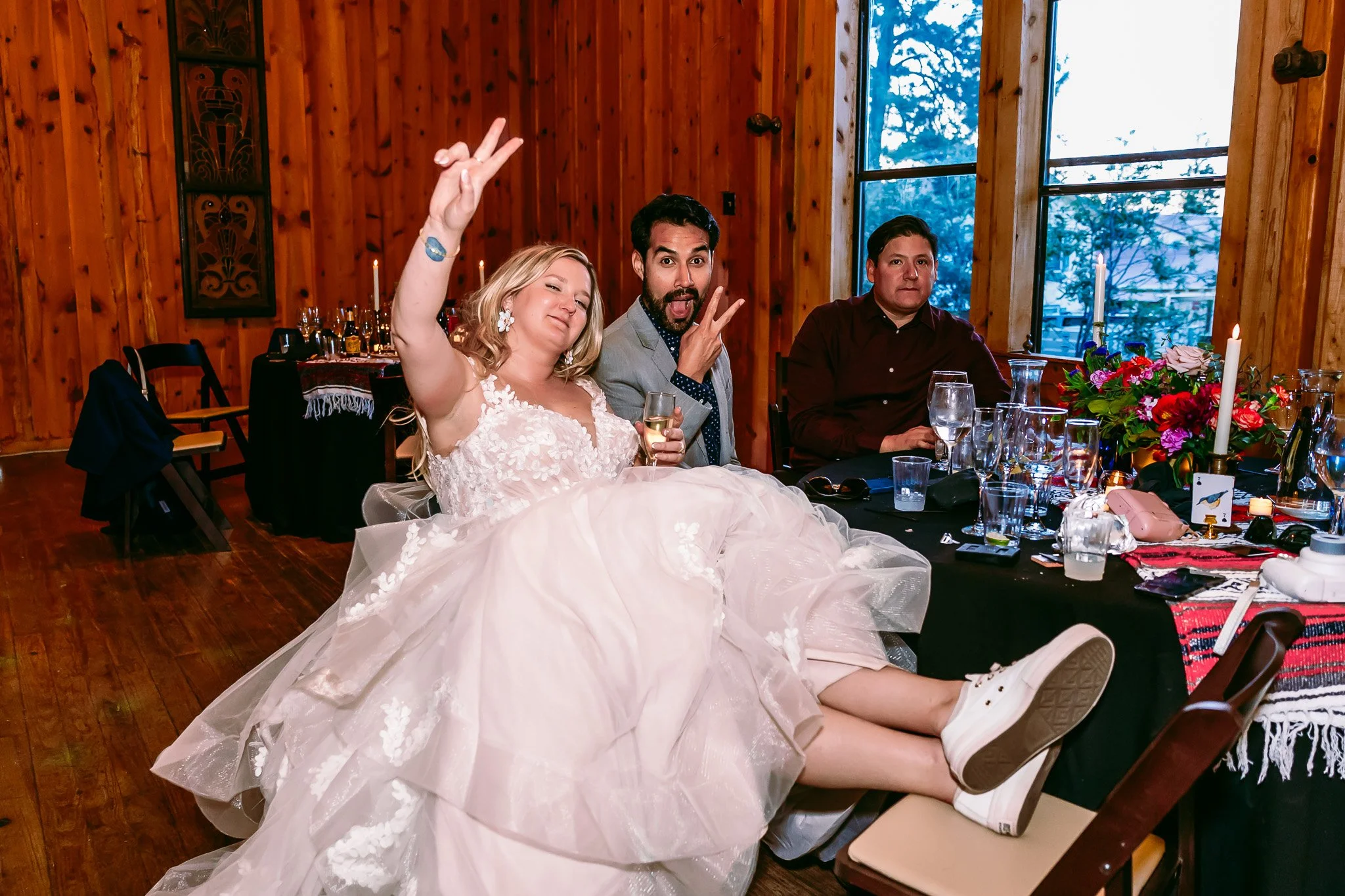 Bride relaxing with wedding guests during the reception celebration at The Lodge Resort in Cloudcroft, New Mexico.