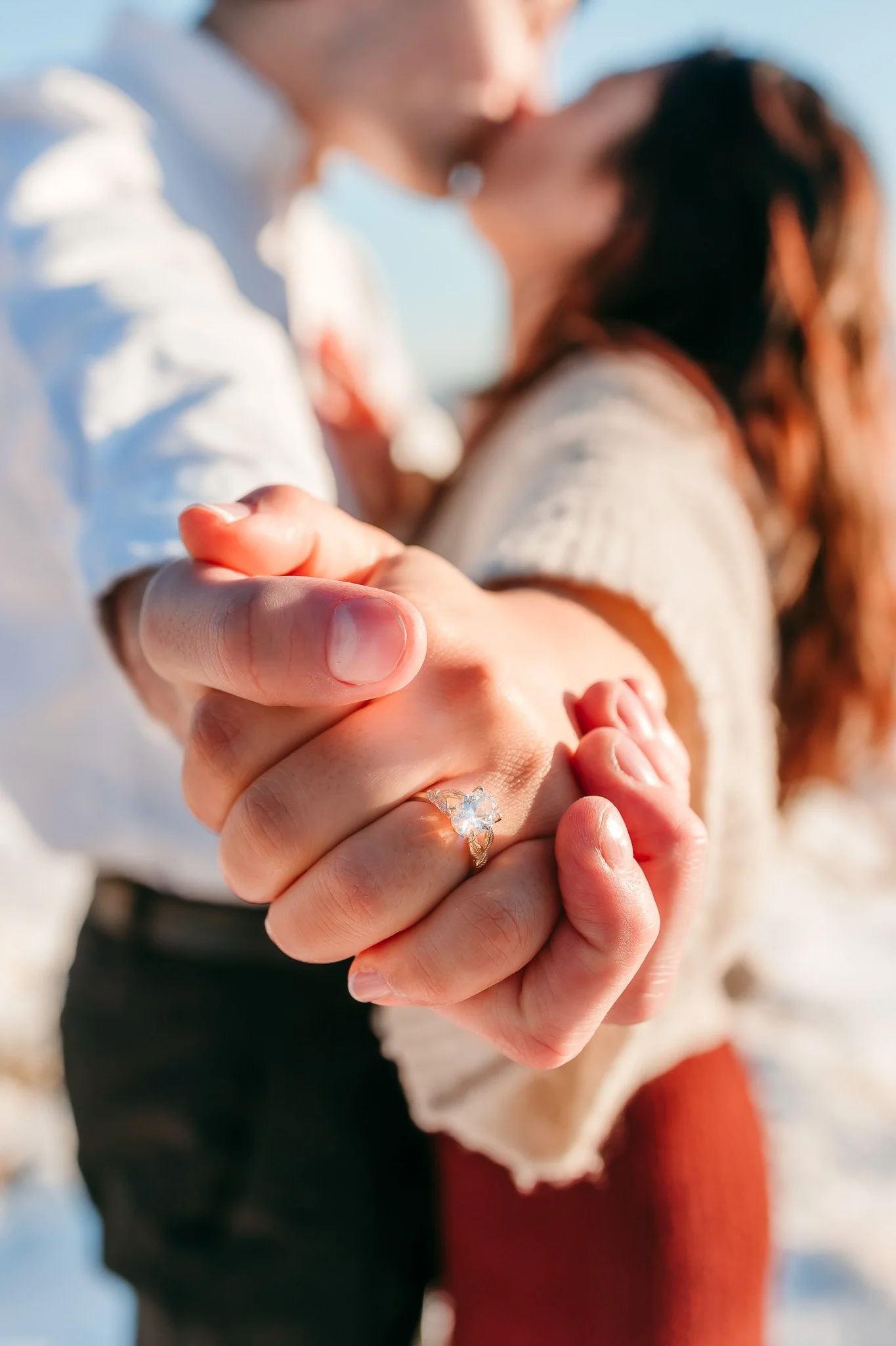 Close-up of the engagement ring as a newly engaged couple holds hands during a surprise proposal at the Guadalupe Mountains near Carlsbad, New Mexico.