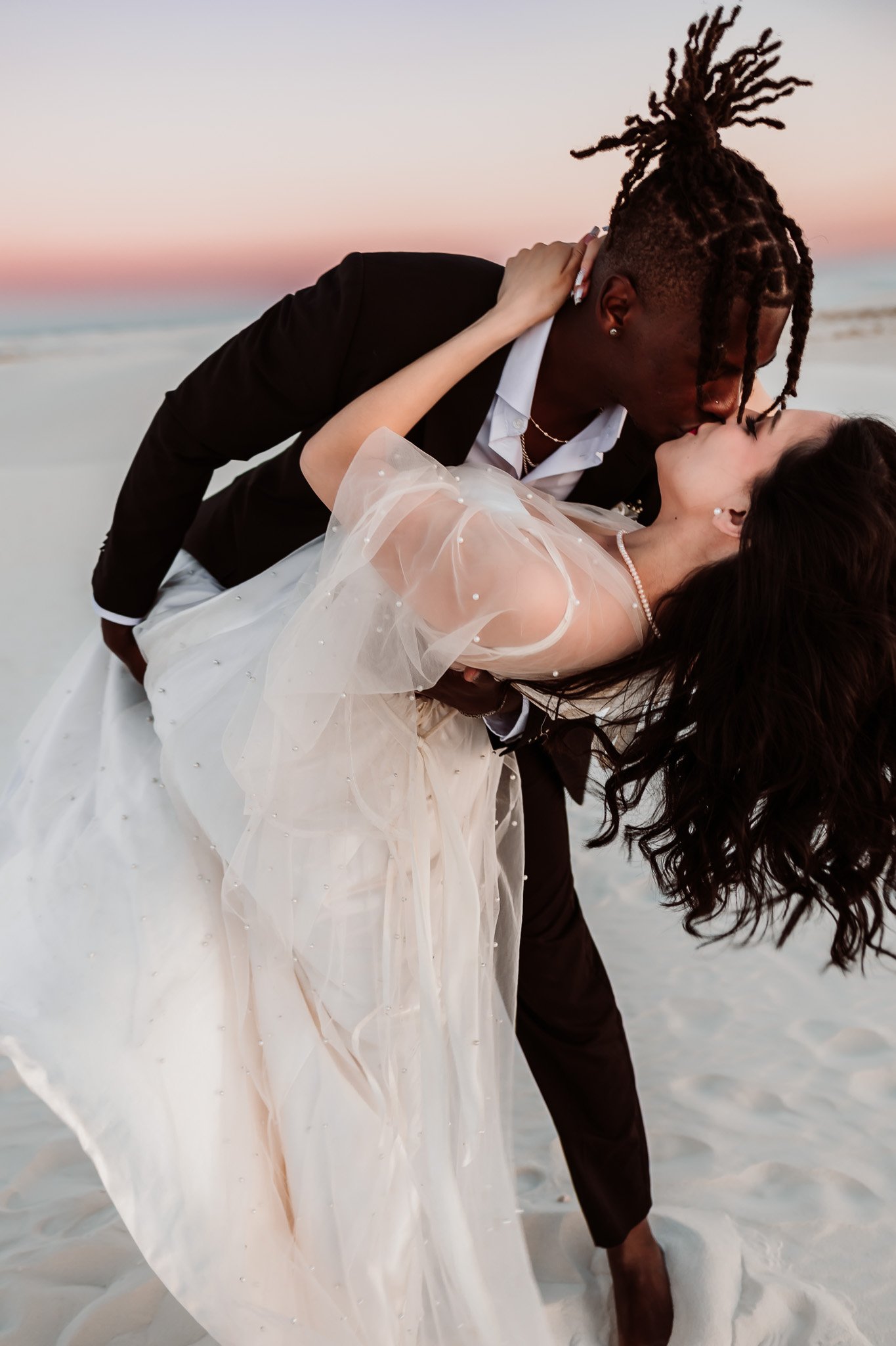 Romantic dip kiss during sunset wedding portraits at White Sands National Park after an intimate New Mexico elopement.