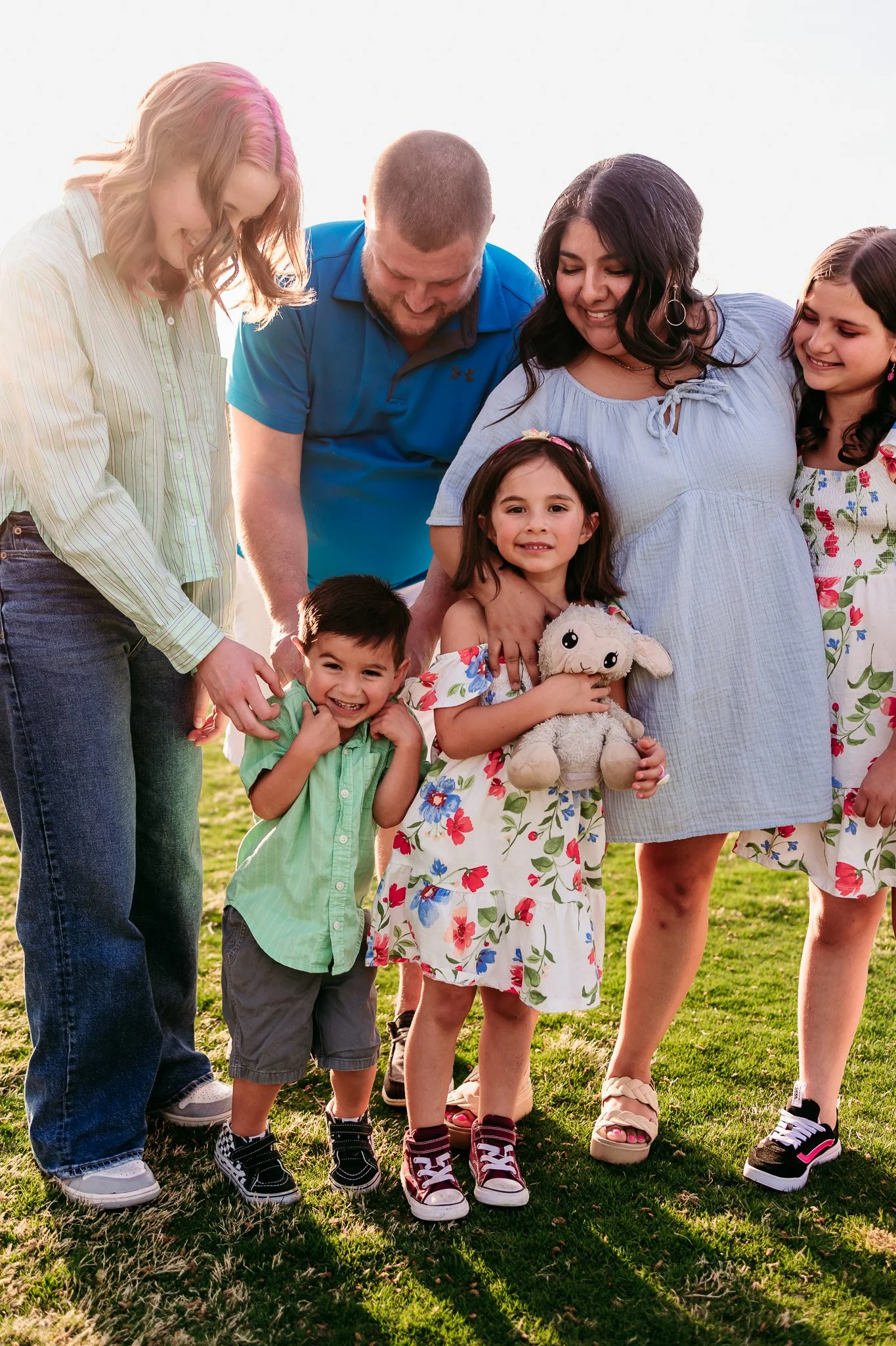 Children smiling while standing together during an outdoor family photography session at NMSU Golf Course.