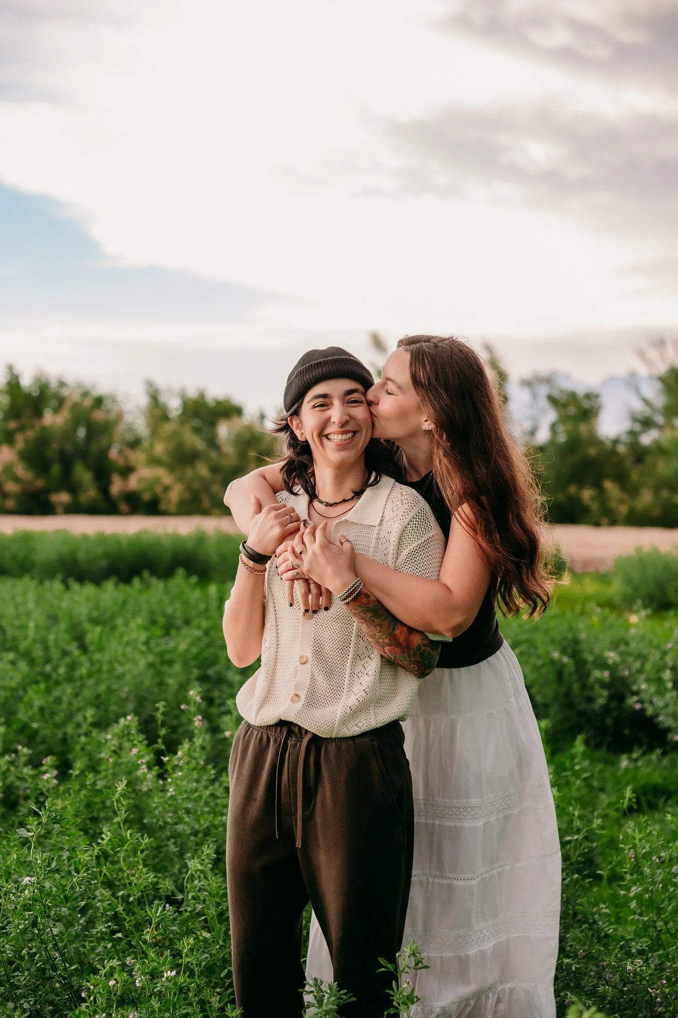 Partners laughing together during a playful couples photography session in Mesilla, New Mexico. LGBT photographer.