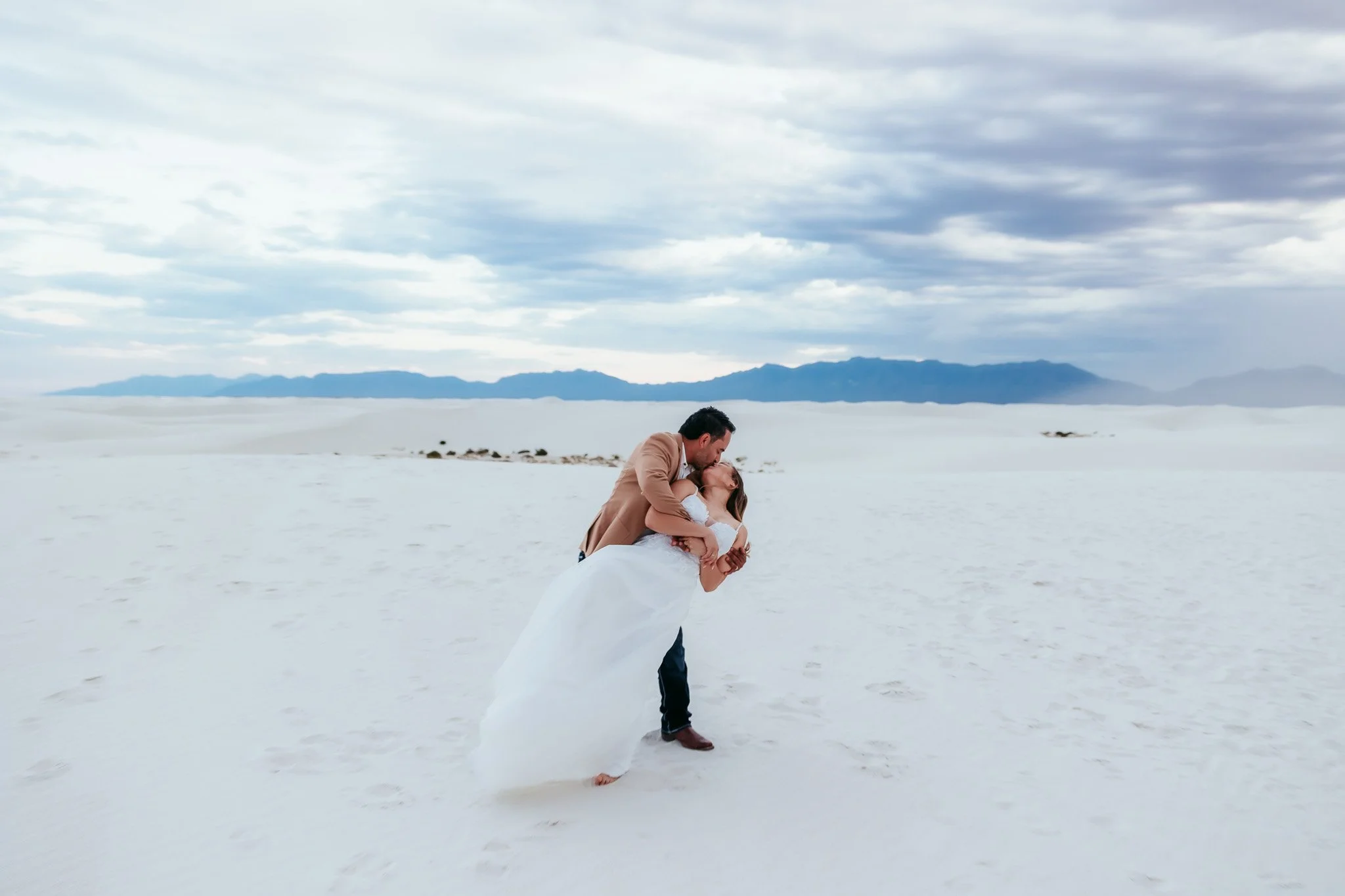 Bride and groom sharing a romantic portrait among the white dunes during their White Sands National Park elopement in New Mexico.