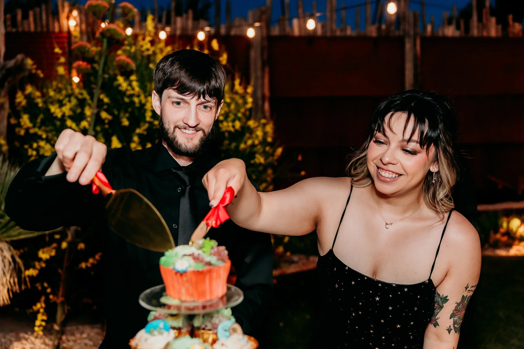 Bride and groom cutting cupcakes together during their intimate wedding reception at The Mystic in Santa Fe, New Mexico.