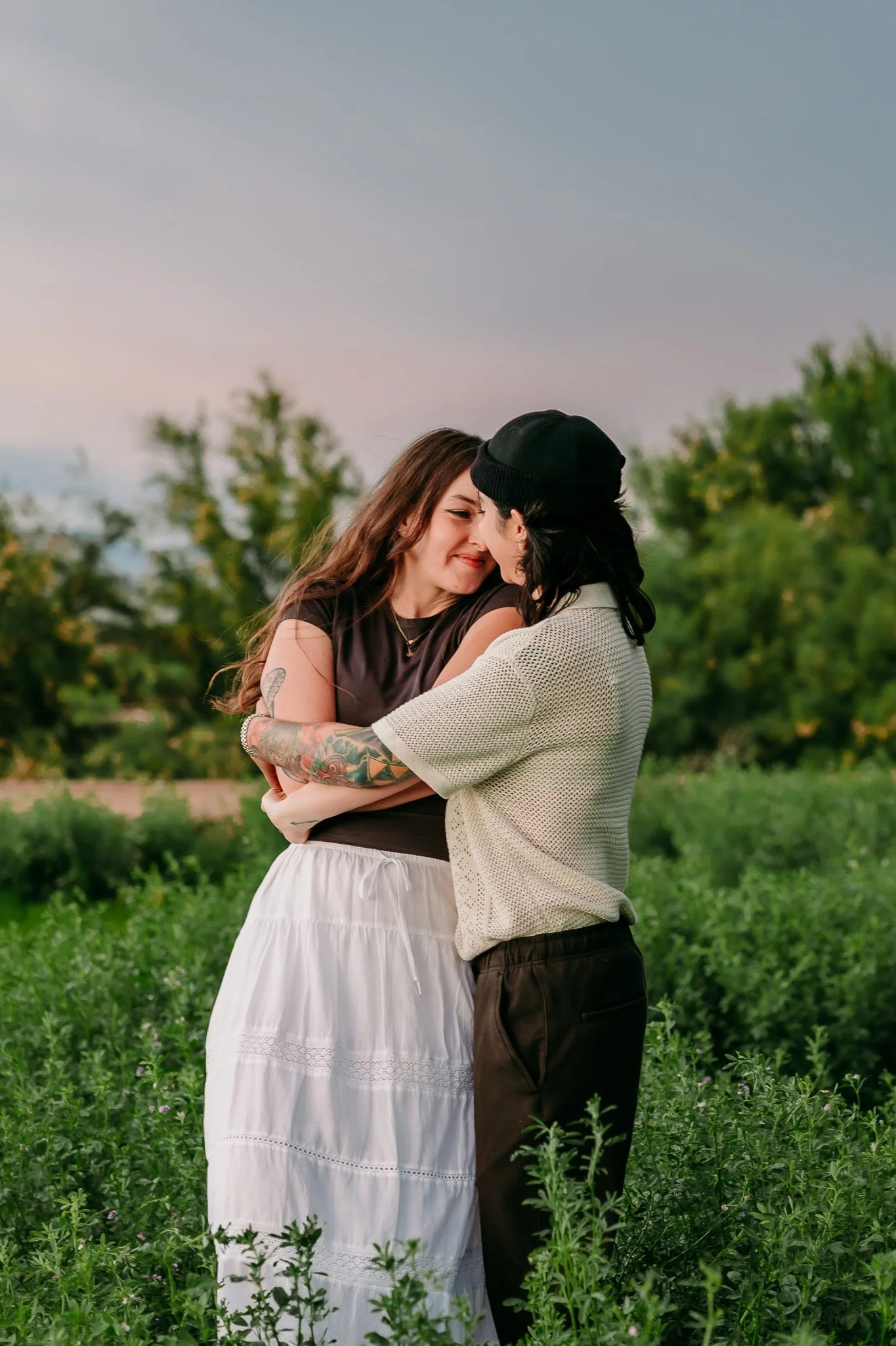 Partners embracing at golden hour during a couples photography session in Mesilla, New Mexico.