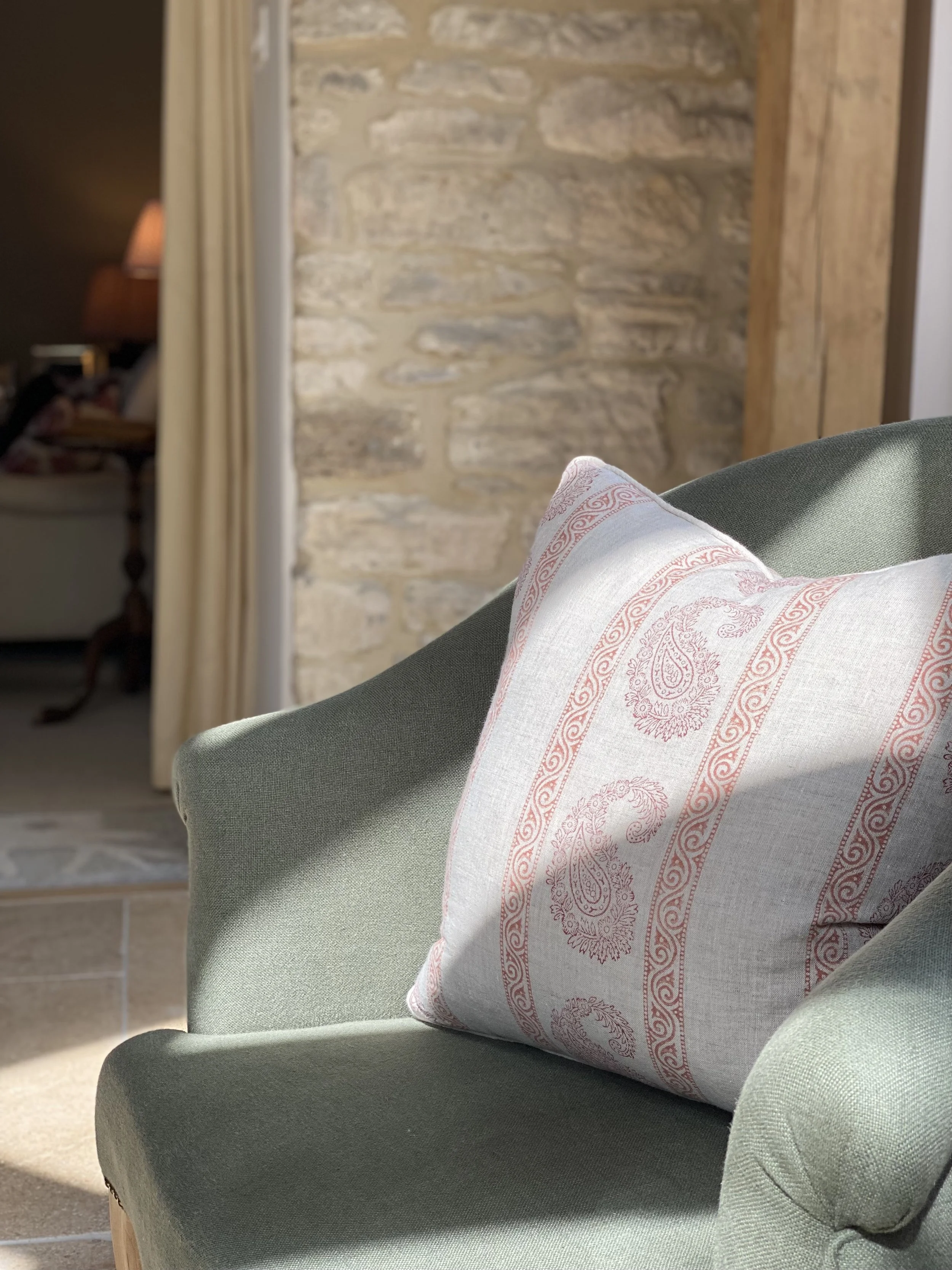 Curated living room featuring soft furnishings, natural materials and timeless interior styling in the Cotswolds