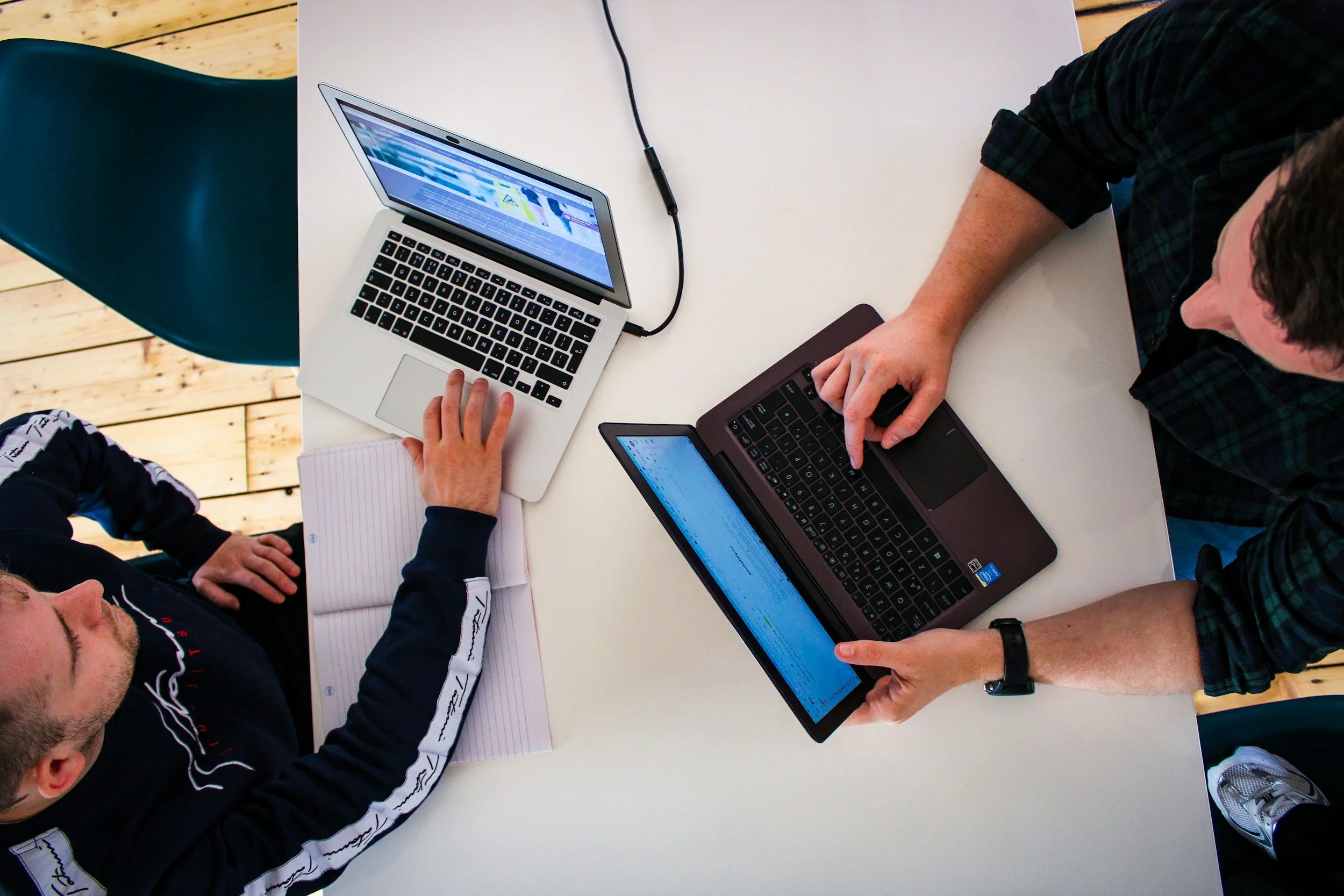 two men on laptops