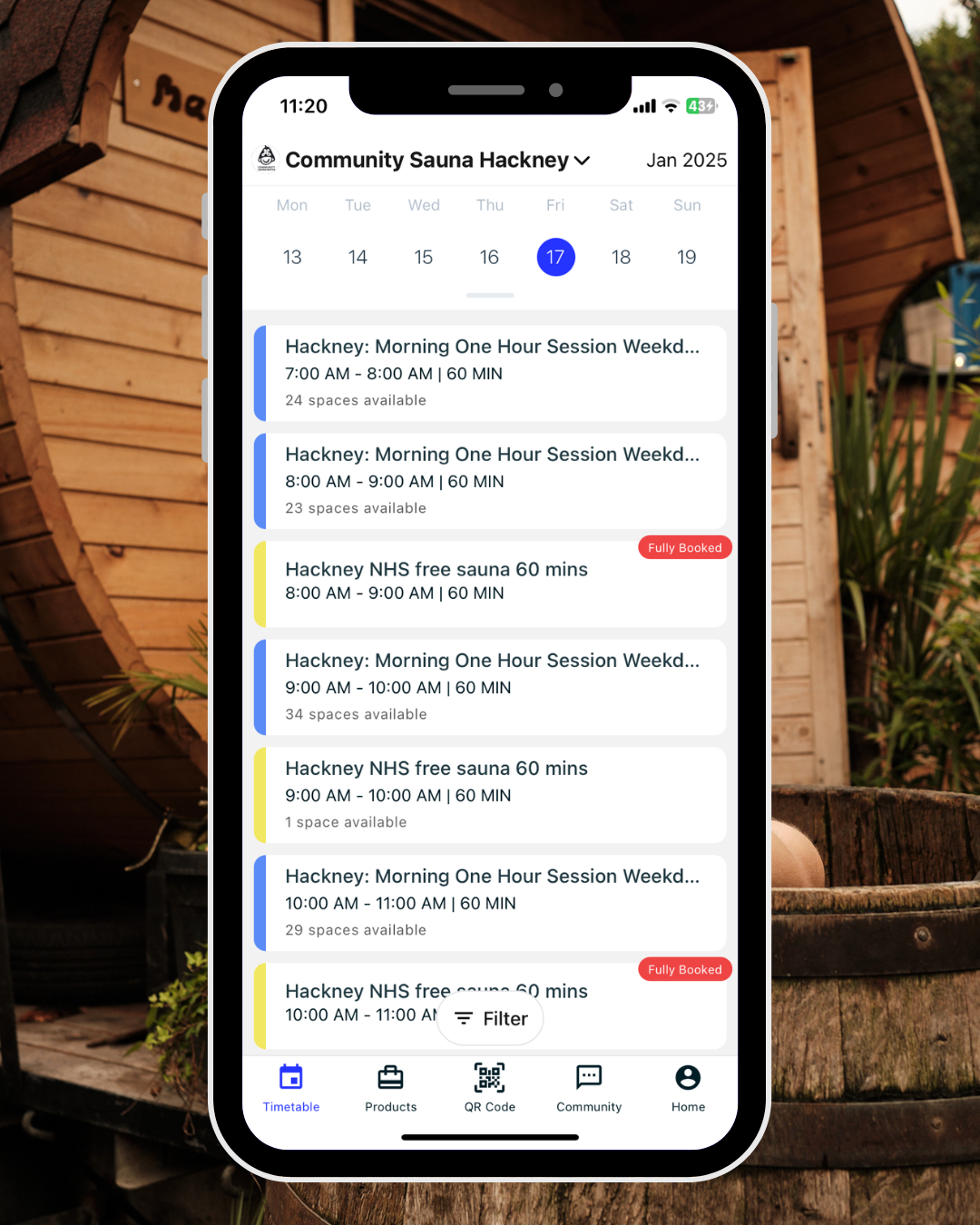 Smartphone displaying calendar schedule for Community Sauna Hackney, with various morning sauna session bookings, some fully booked, in January 2025.