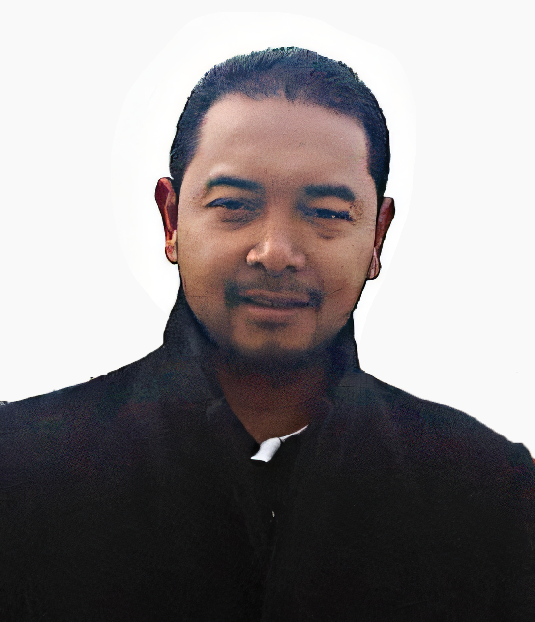 Headshot of a man in a suit, white shirt, and blue tie, smiling against a dark background.