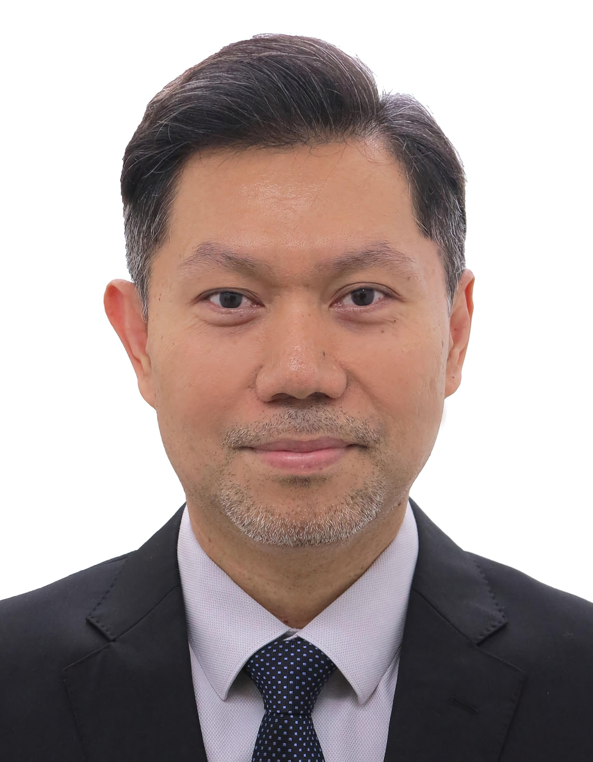 Professional headshot of a smiling man in a navy suit, light blue shirt, and black tie against a dark background.
